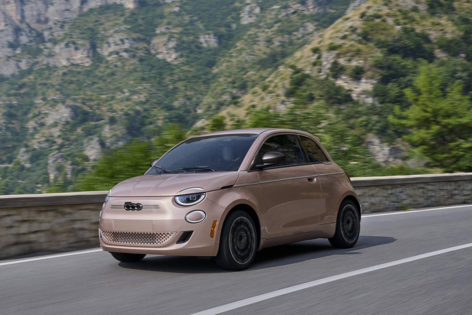 2026 Fiat 500e Icona in Rose Gold front angled view driving