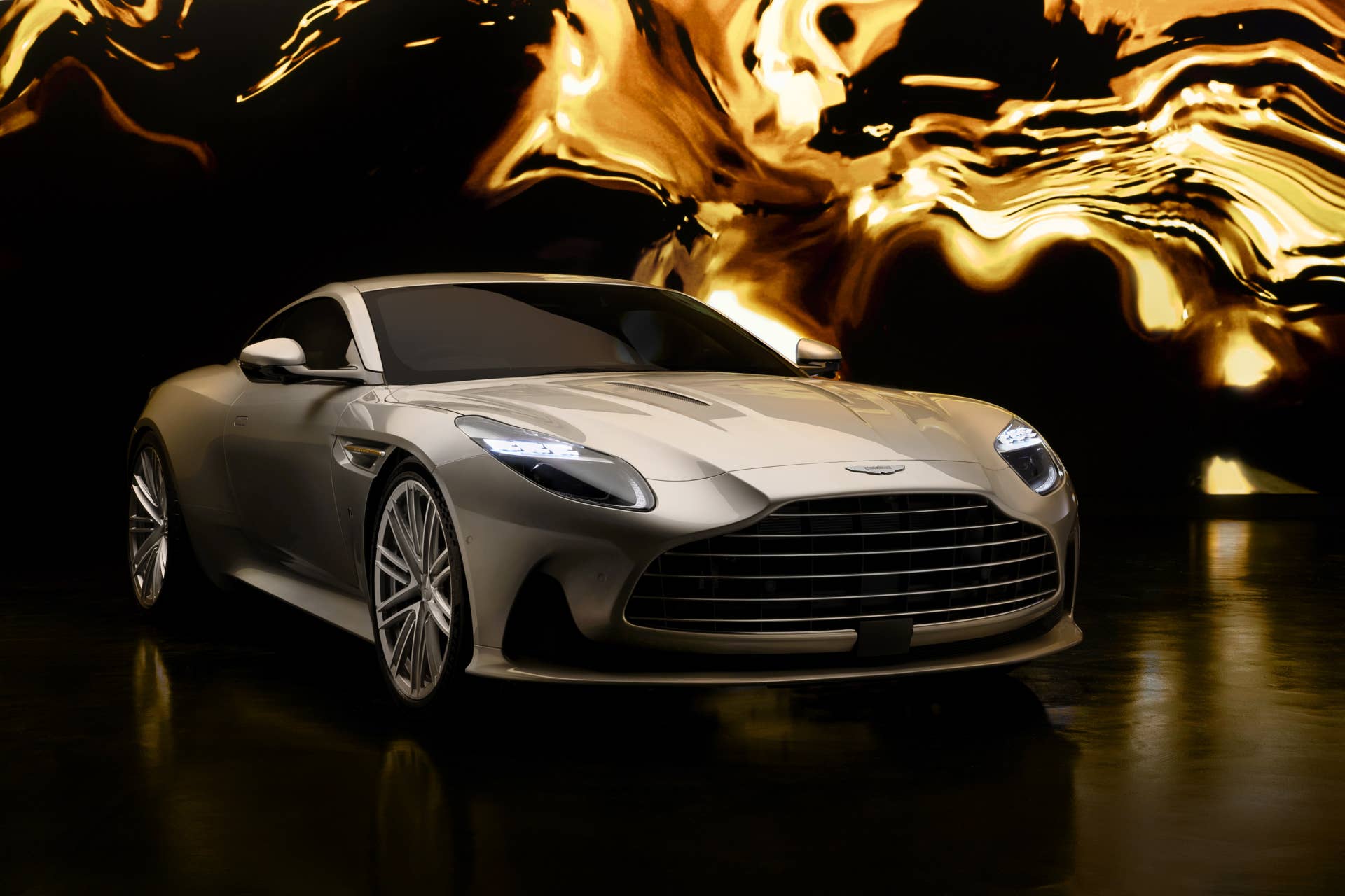2026 Aston Martin DB12 Coupe Goldfinger Edition in gold front angled view
