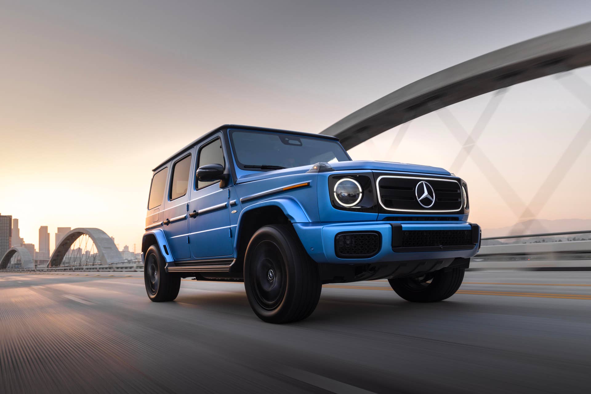 2025-2026 Mercedes-Benz G-Class EV in blue front angled view driving