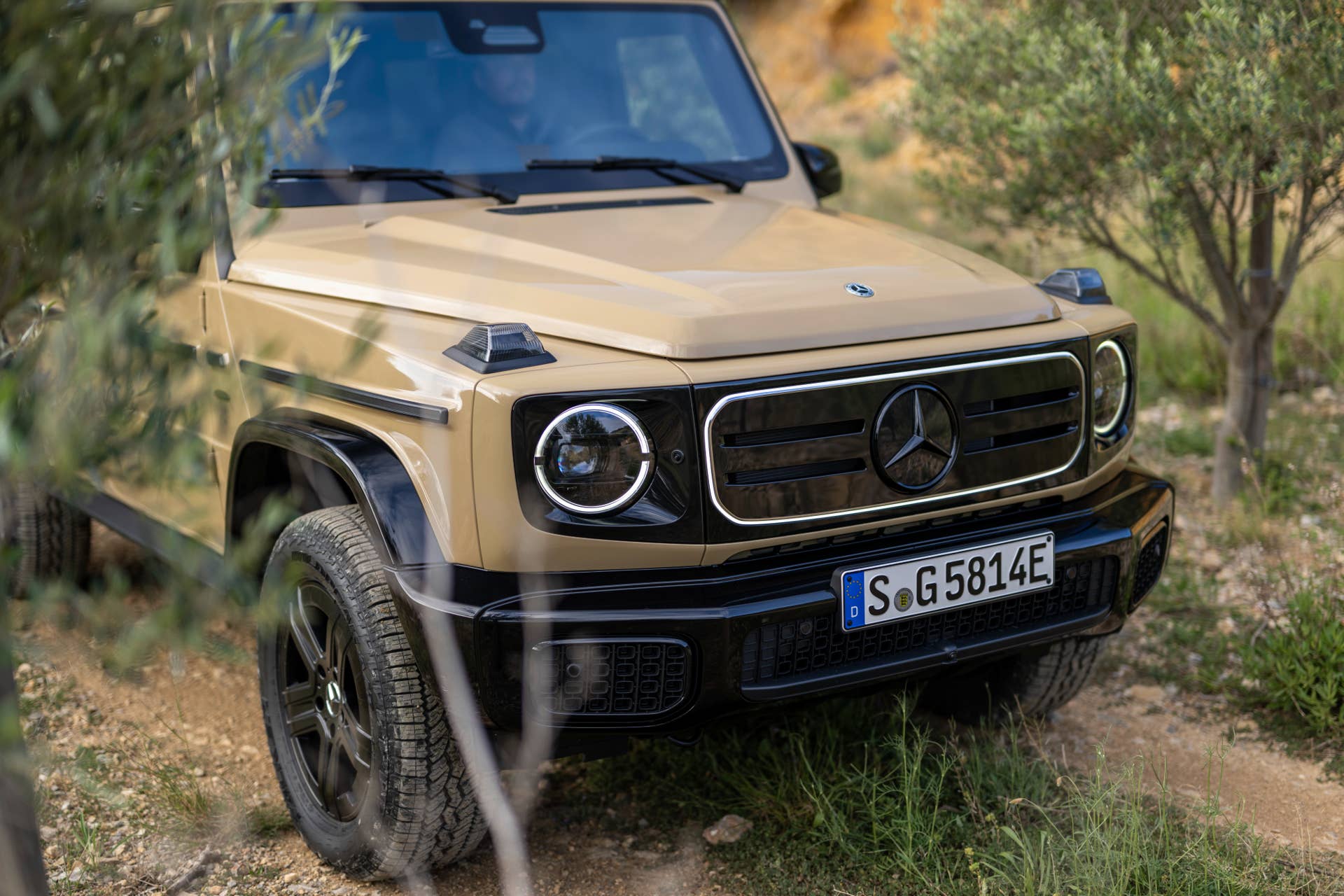 2025-2026 Mercedes-Benz G-Class EV in Manufaktur Desert Sand front angled view closeup