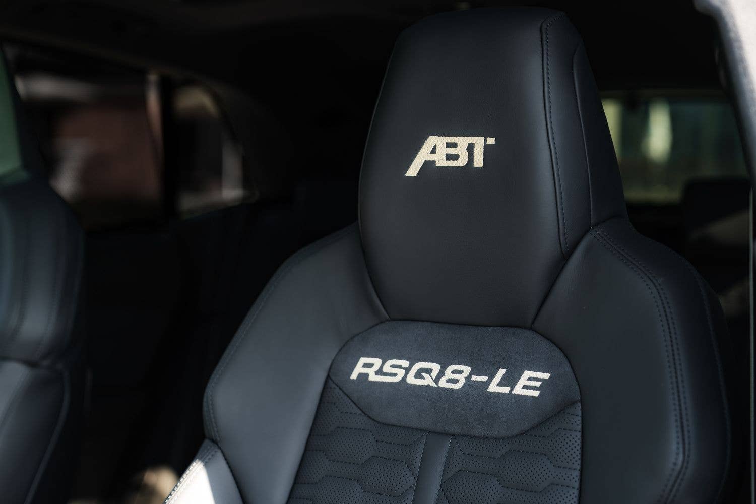 Dark green ABT RSQ8-LE 1000 parked with gold wheels and carbon detailing