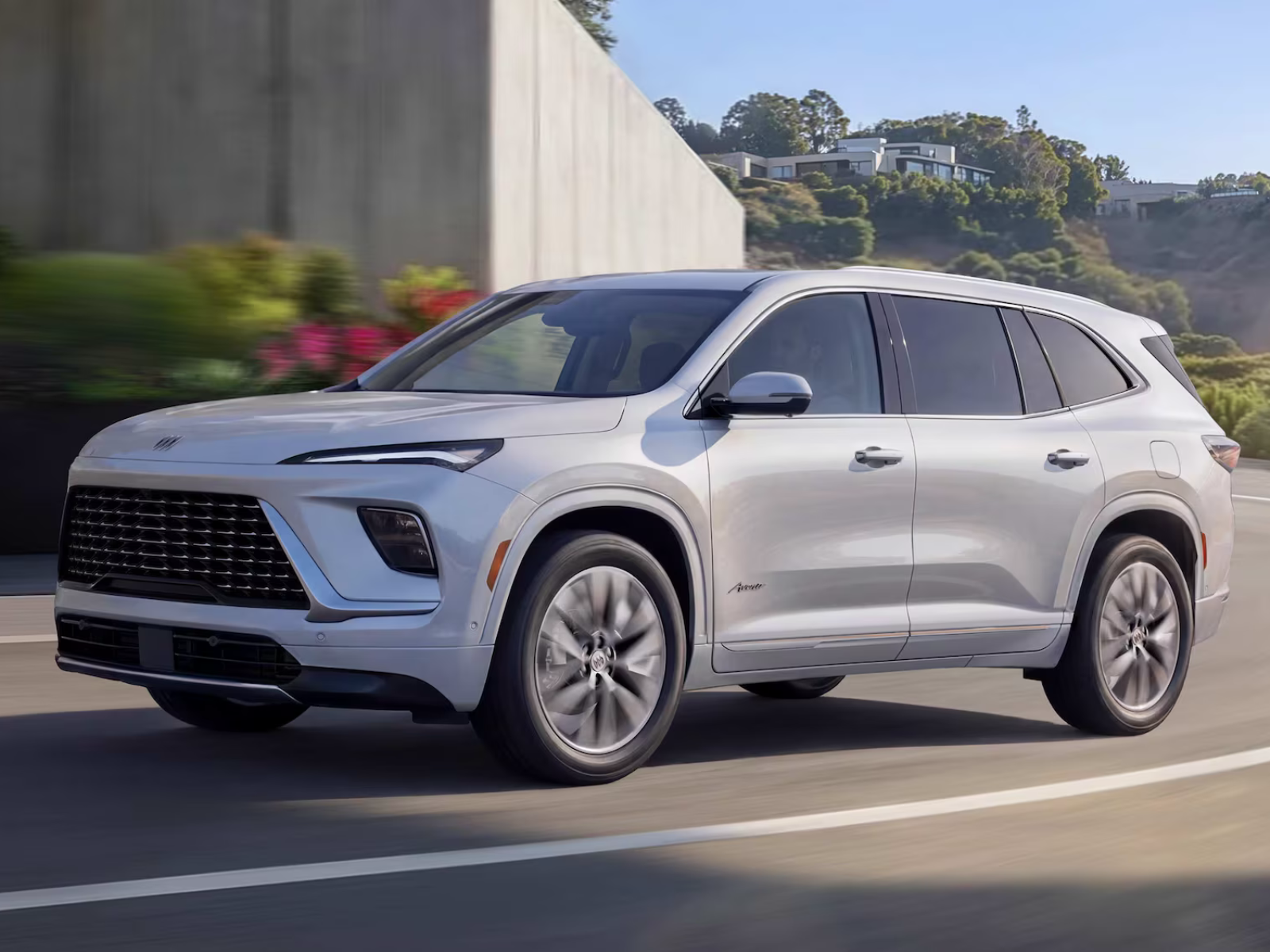 2027 Buick Enclave Avenir in Iridescent White front angled view driving