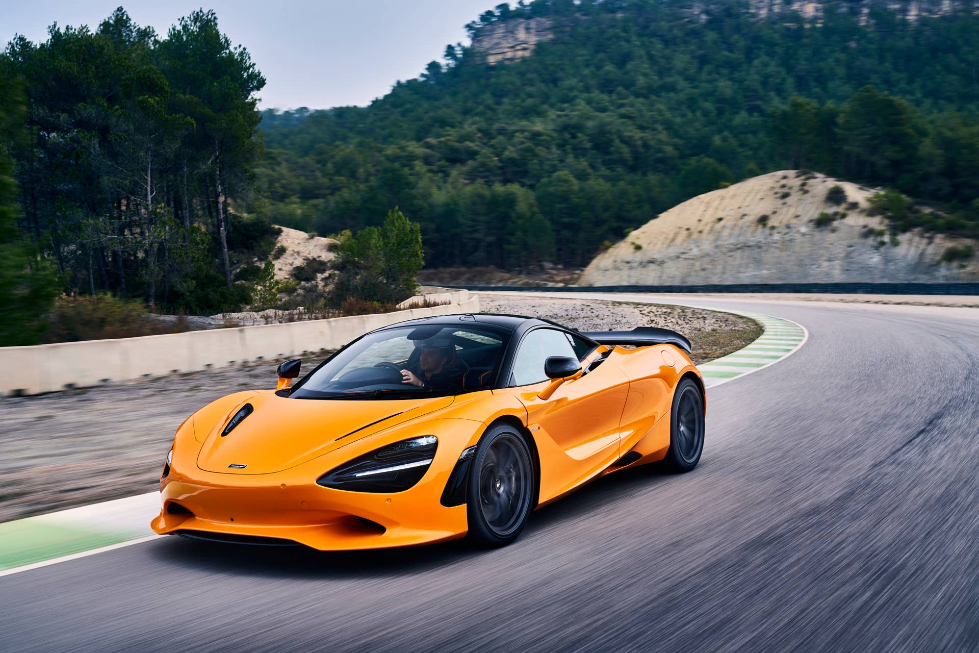 2025-2026 McLaren 750S in orange front angled view driving