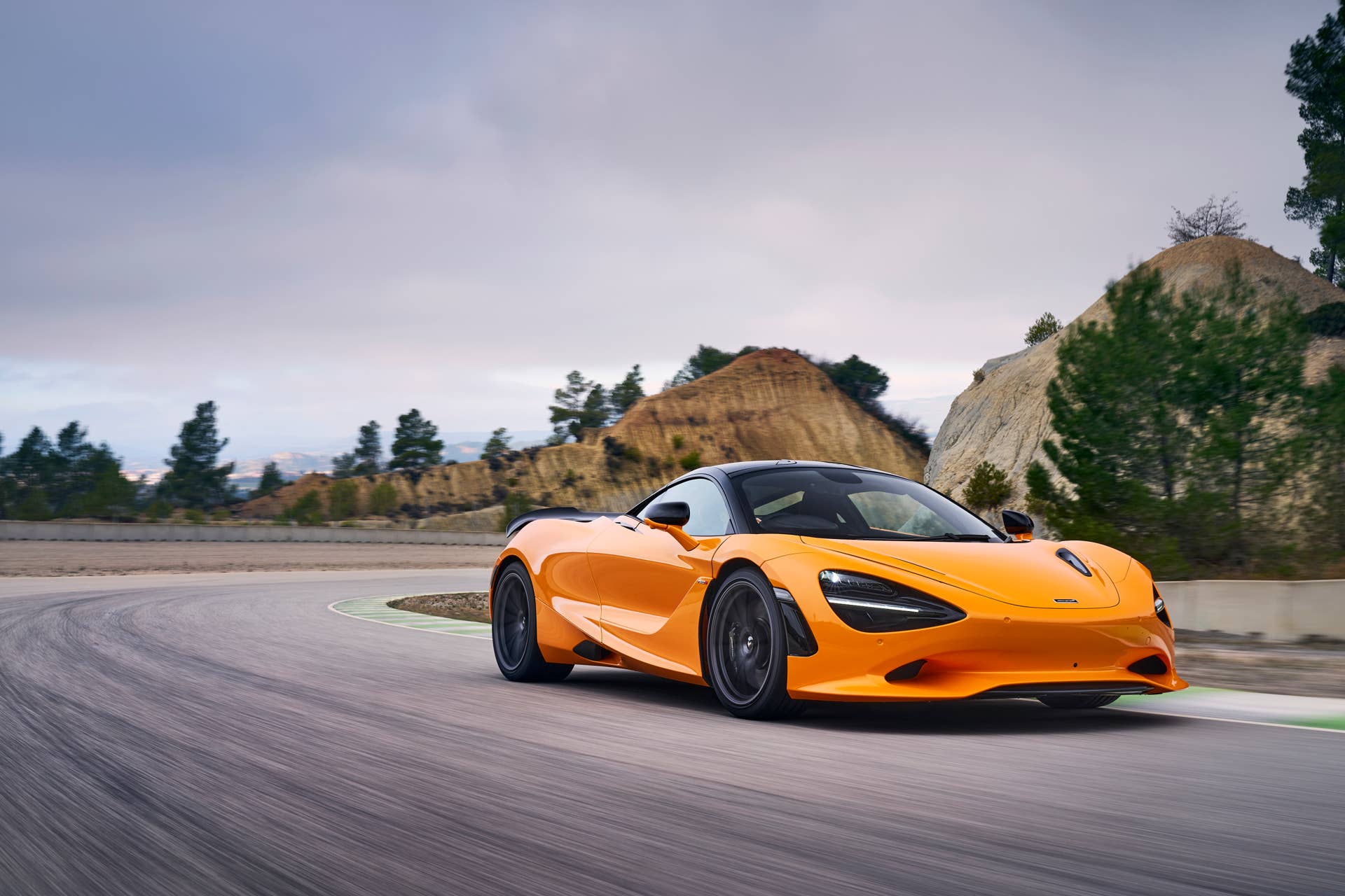 2025-2026 McLaren 750S in orange front angled view driving