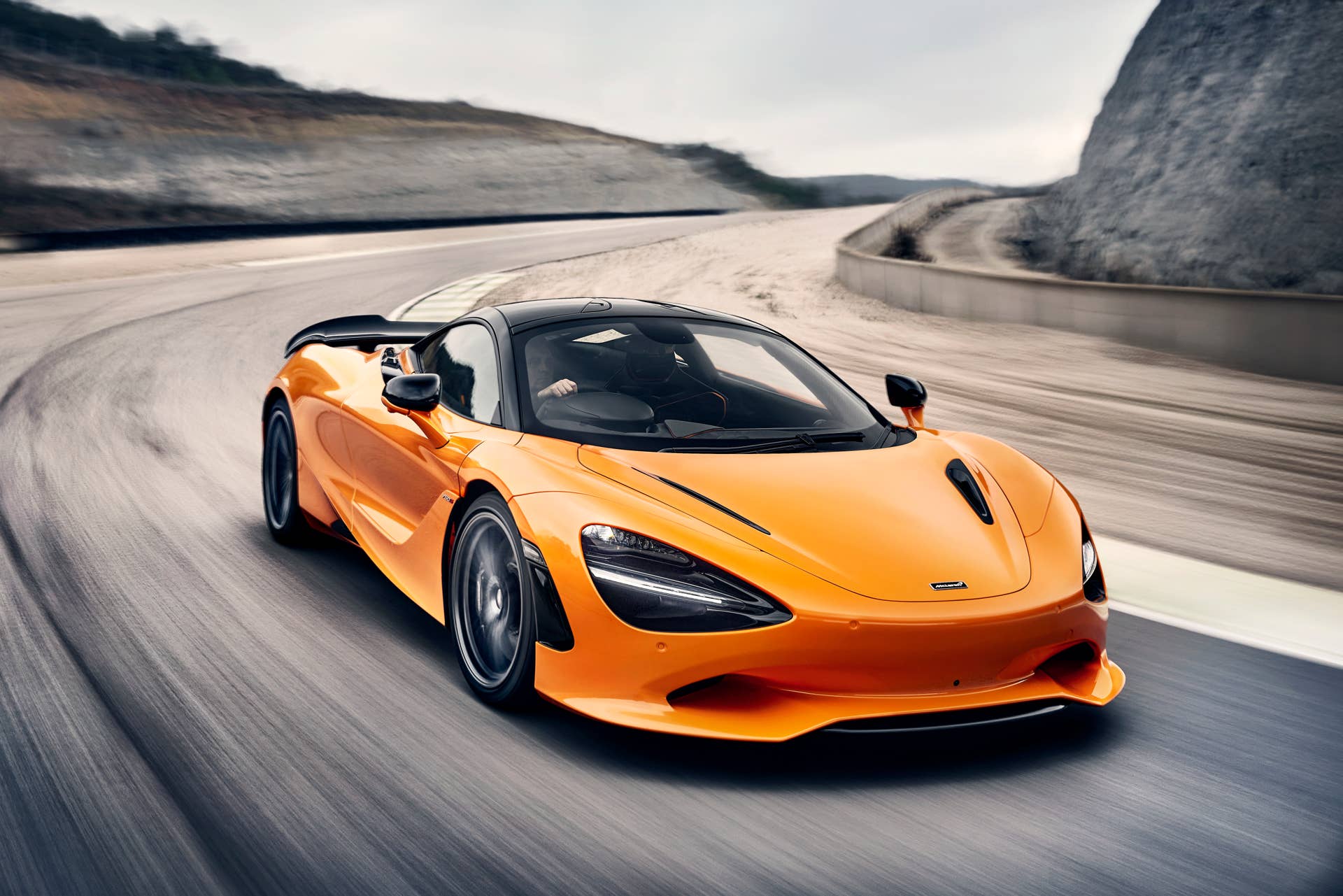 2025-2026 McLaren 750S in orange front angled view driving