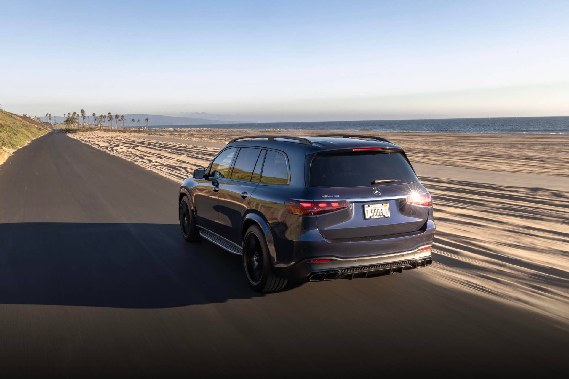 2025-2026 Mercedes-AMG GLS 63 in gray rear angled view driving