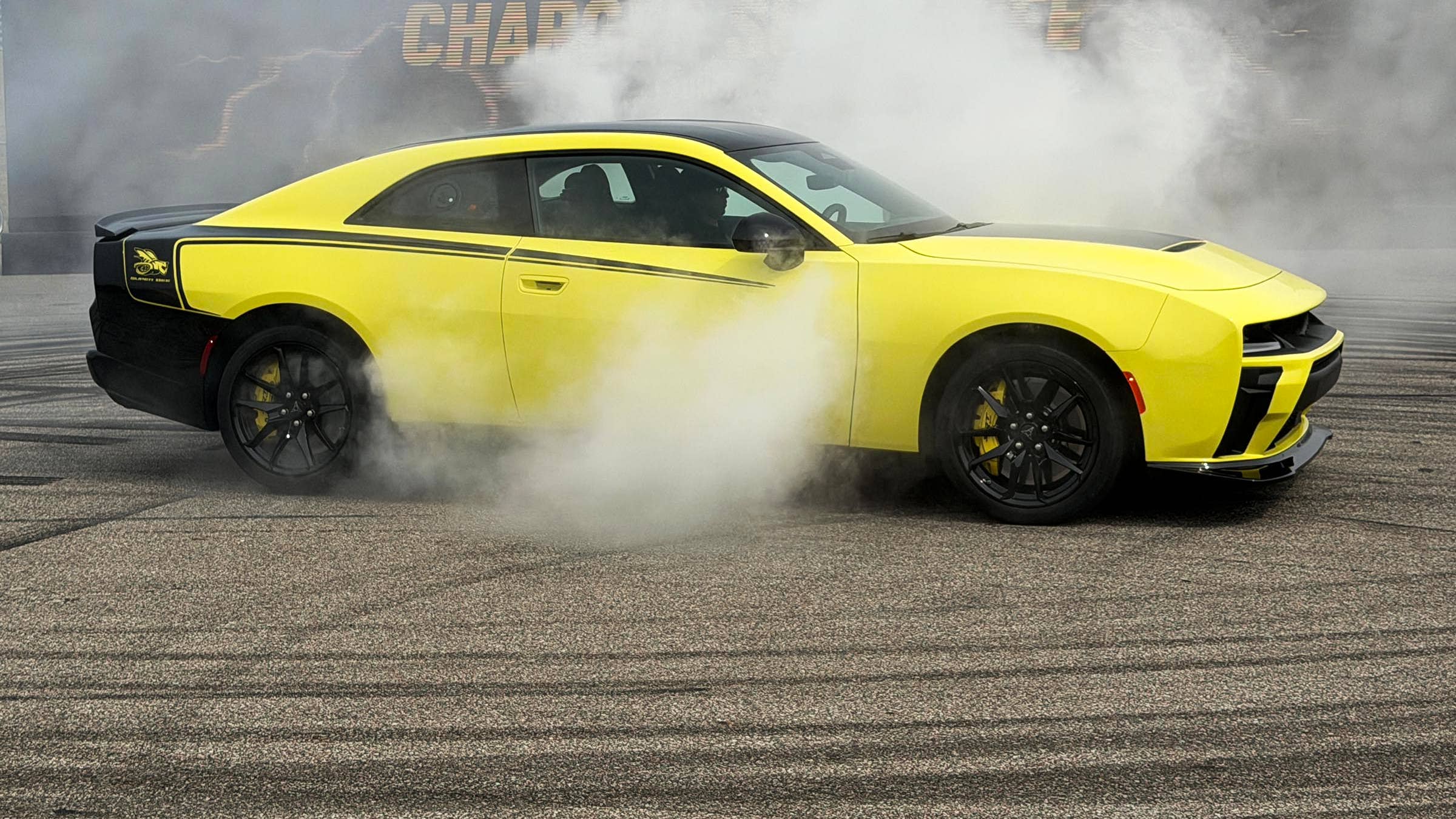 2027 Dodge Charger Super Bee Launch Edition 2-door in yellow front angled view burning rubber