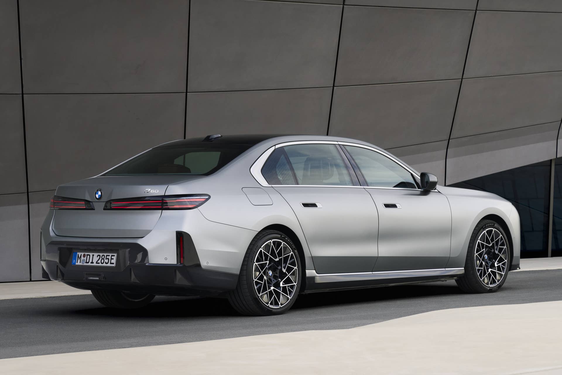 2027 BMW i7 60 xDrive in silver rear angled view
