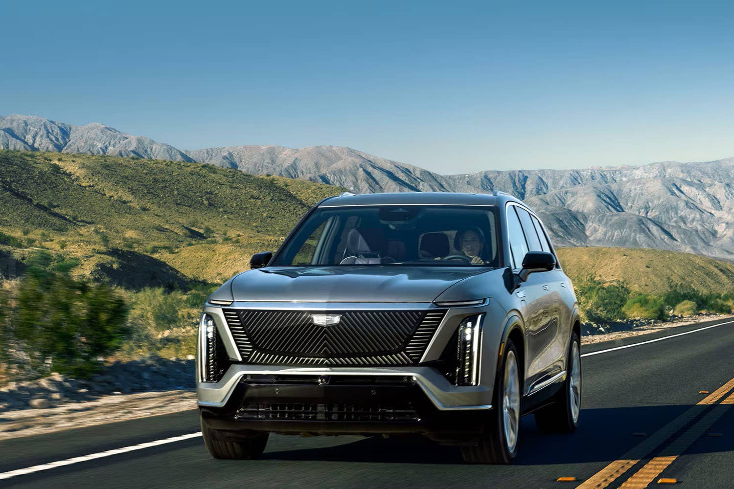 2027 Cadillac Vistiq in Argent Silver front angled view driving