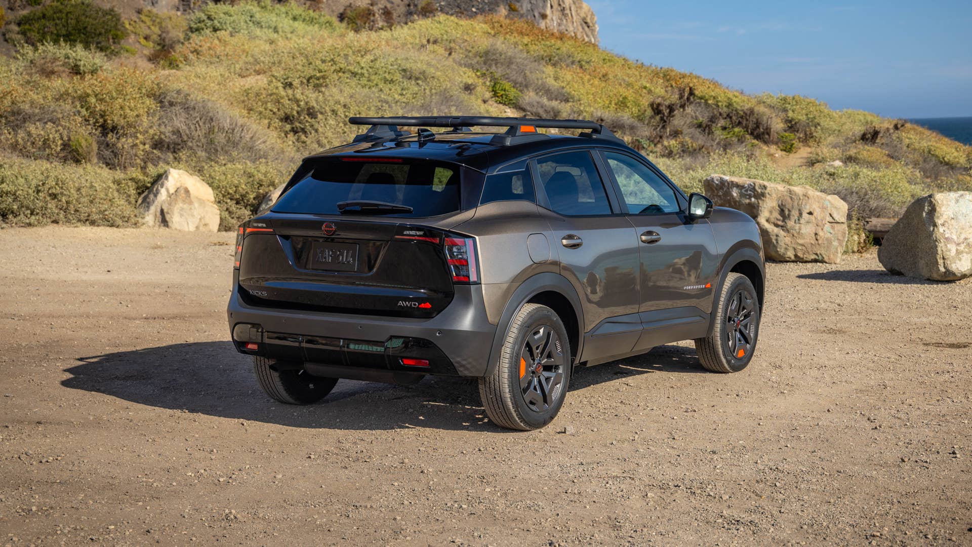 2027 Nissan Kicks Rock Creek in Canyon Bronze rear angled view