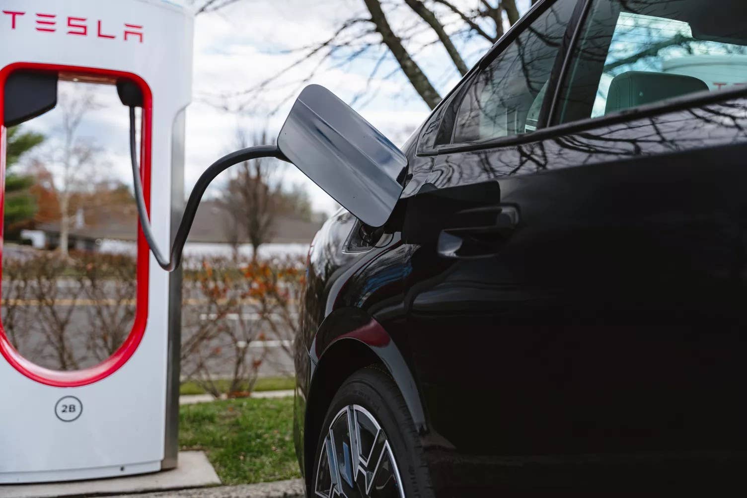 BMW charging at a Tesla Supercharger
