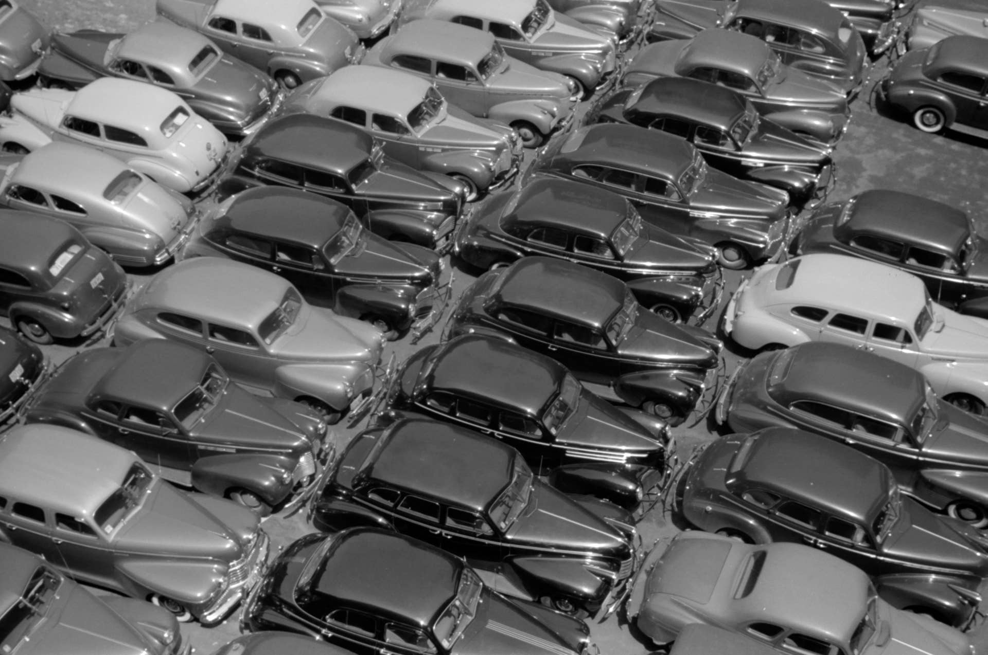 Aerial view of a parking lot showing the roofs of cars tightly arranged bumper to bumper in a grid form, Chicago, Illinois, July 1941.