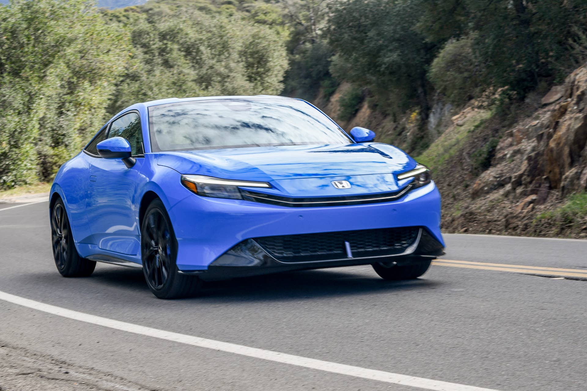 2027 Honda Prelude driving up a windy road