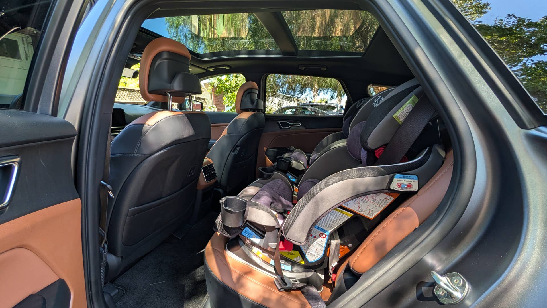 The rear seats of the 2026 Kia Sportage X-Line SX Prestige PHEV with car seats installed
