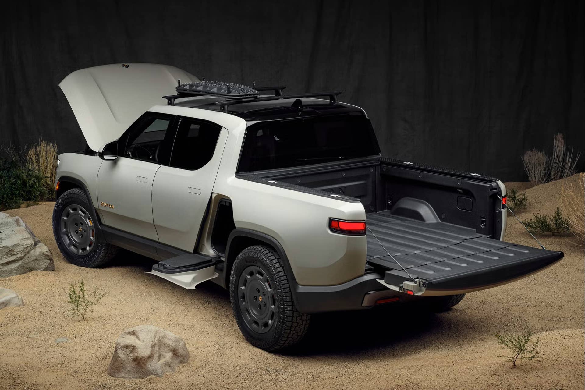 2025 Rivian R1T California Dune Edition in California Dune rear angled view tailgate and hood open