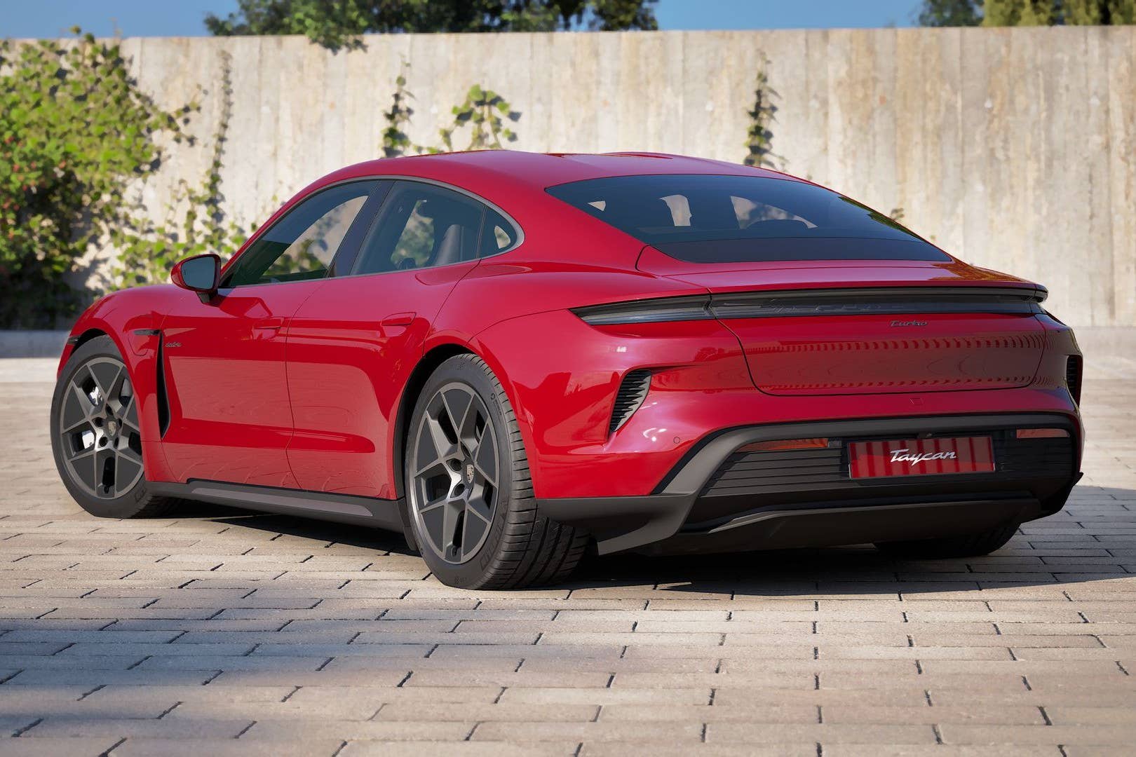 2027 Porsche Taycan Turbo in Carmine Red rear angled view