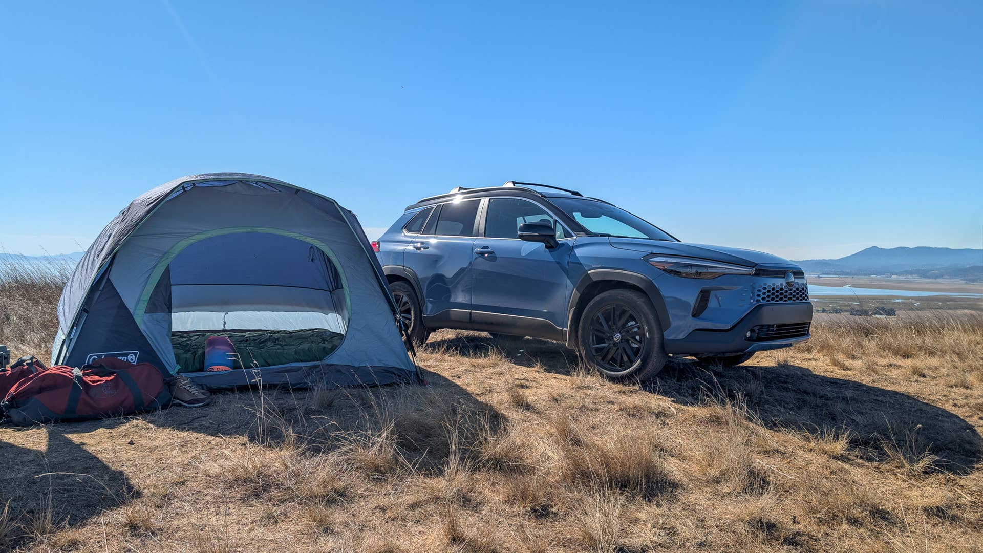 The 2026 Toyota Corolla Cross hybrid on top of a hill at a campsite