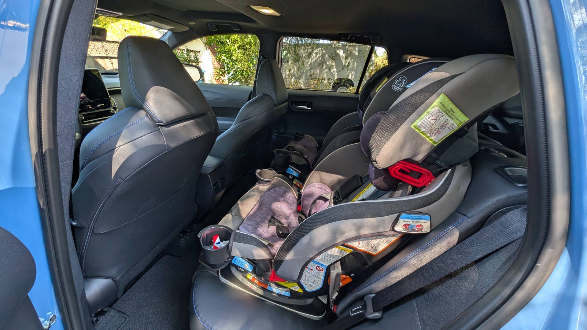 My daughters' car seats installed in the back of a 2026 Toyota Corolla Cross hybrid XSE