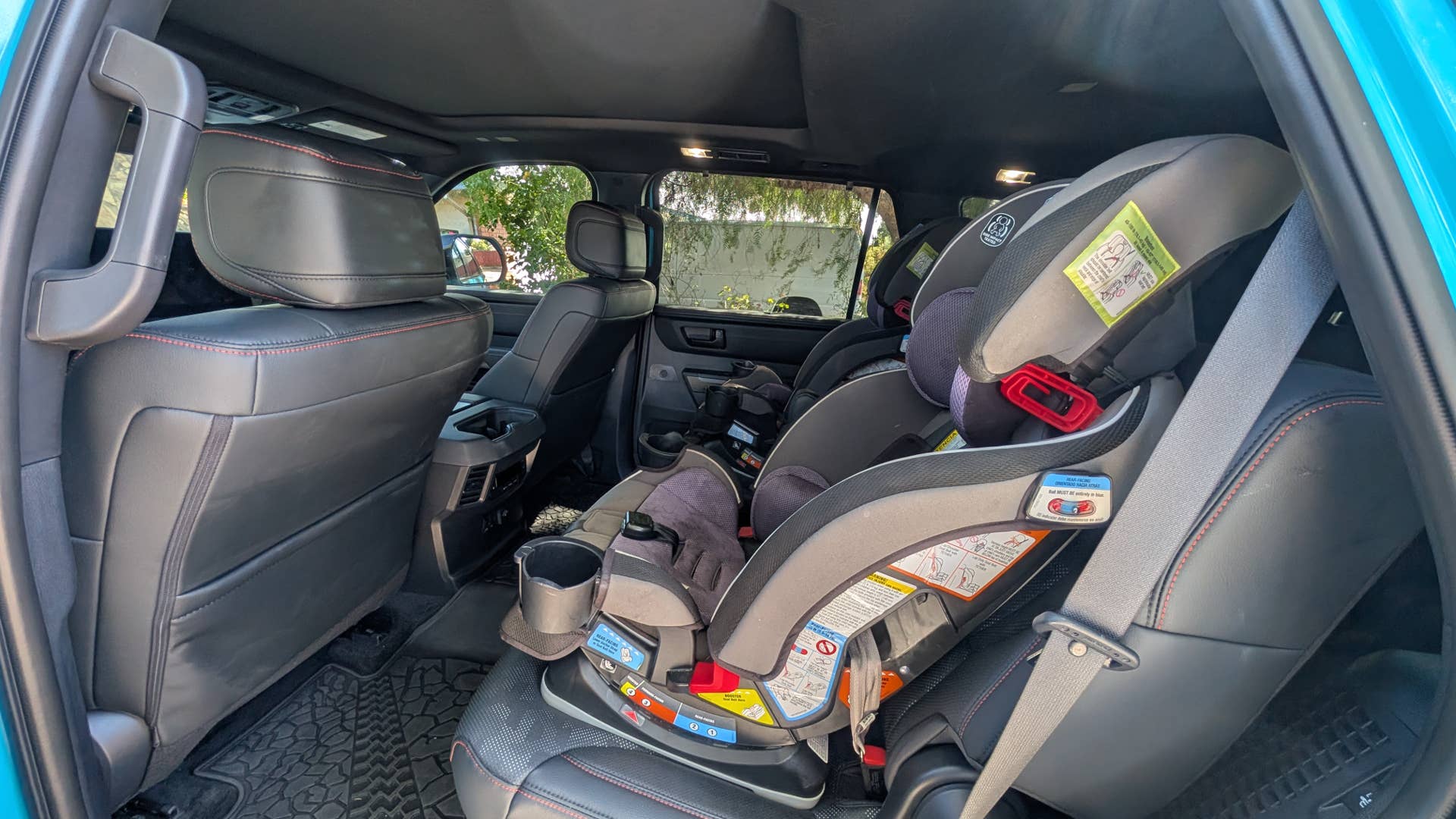 The rear seats of the 2026 Toyota Sequoia TRD Pro with car seats installed