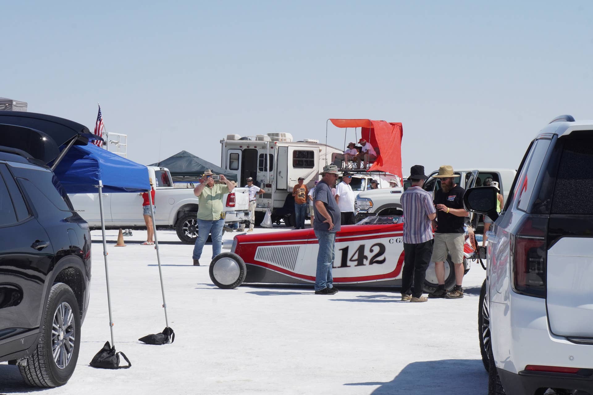 Attendees talk to competitors, as they wait for their turn on the start line during Bonneville Speed Week.
