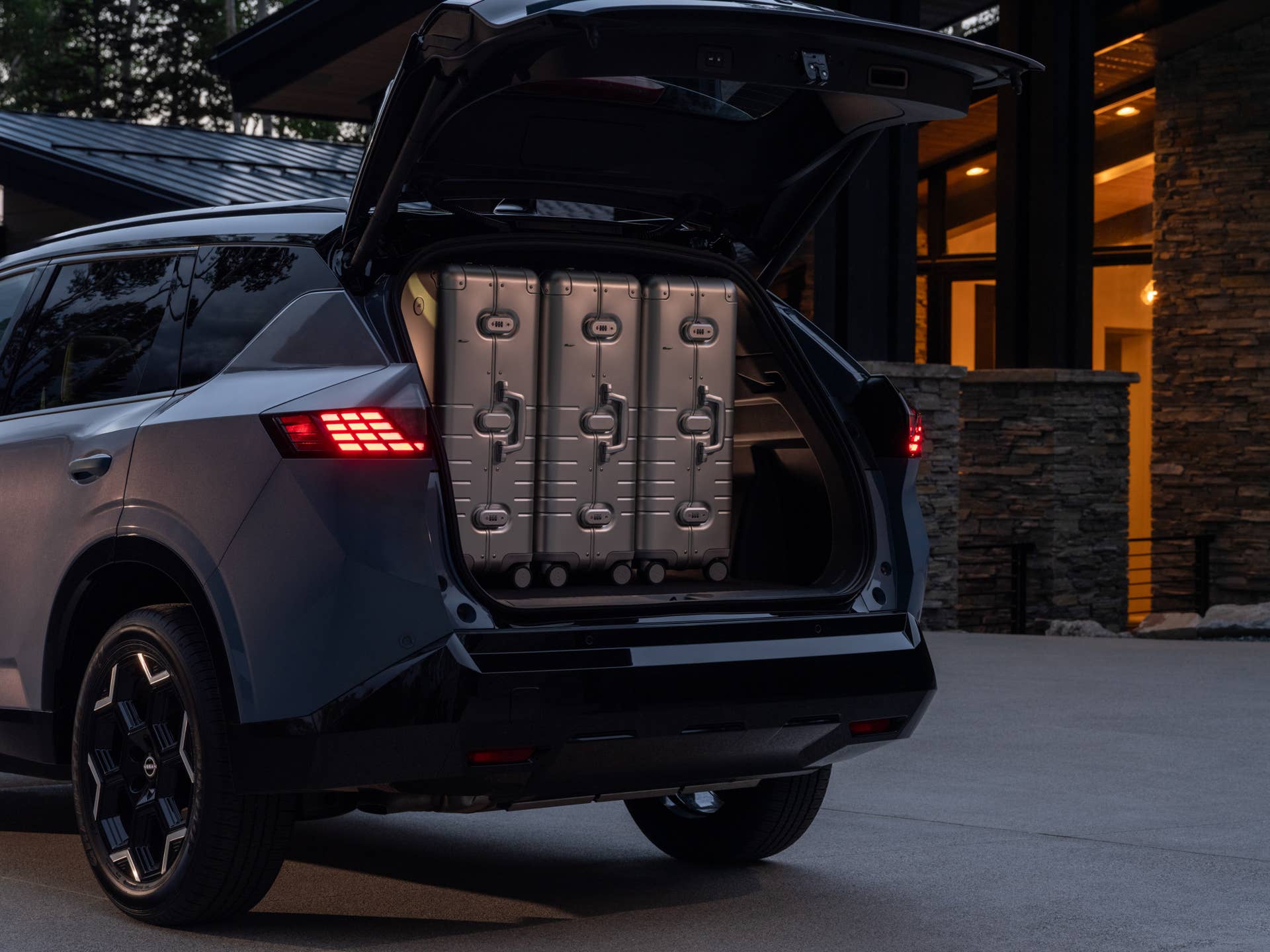 Three suitcases in the back of the 2027 Nissan Rogue Hybrid Platinum at sunset.