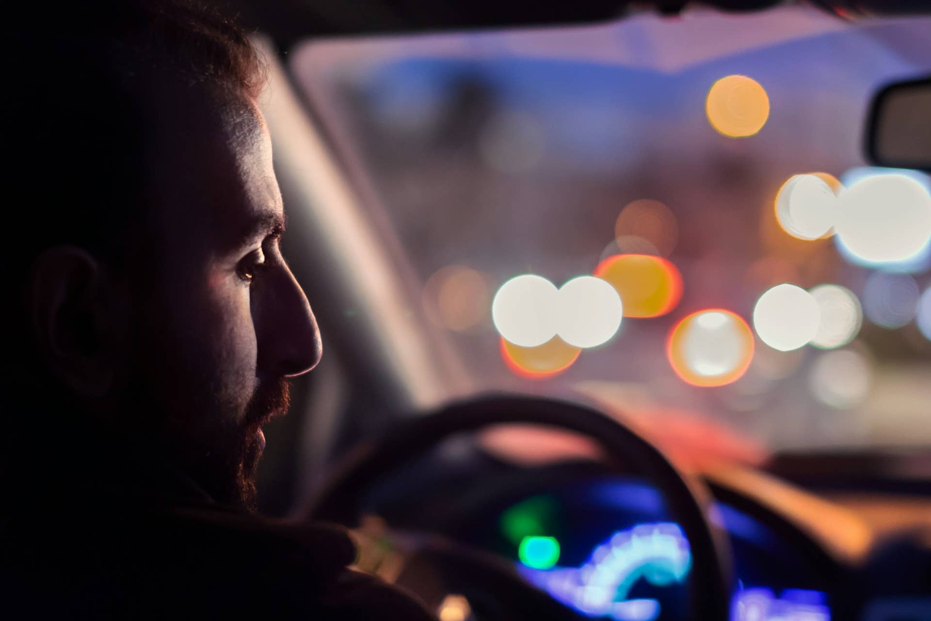 Driver in car at night