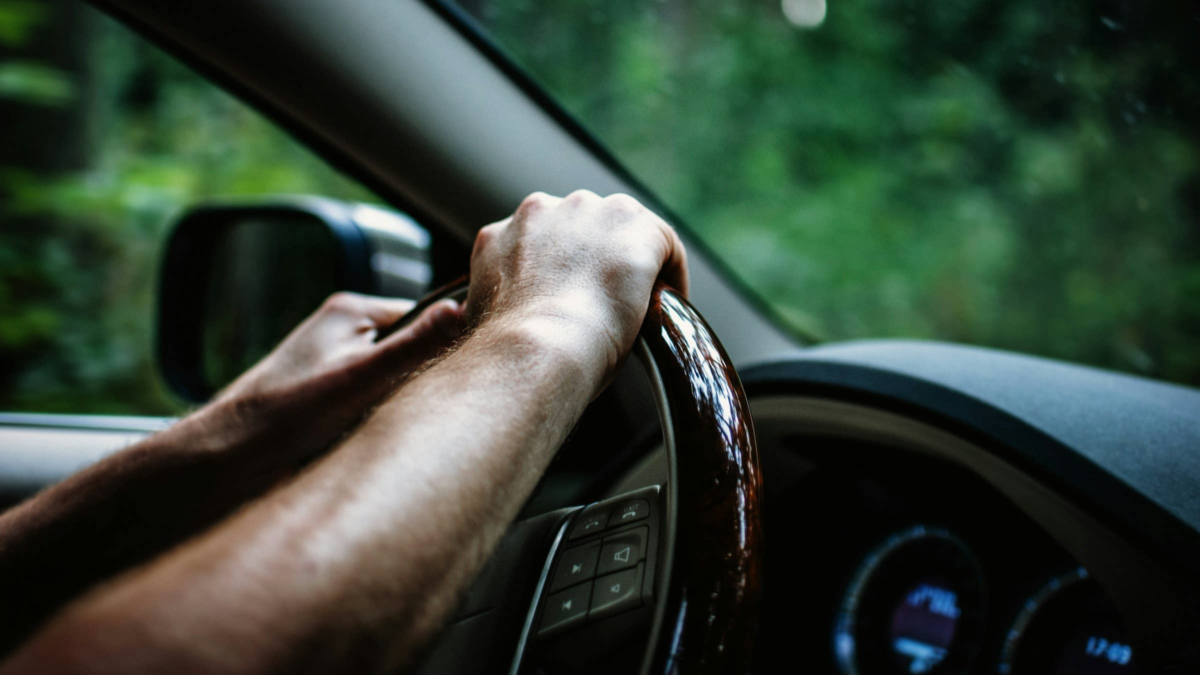 Driver's hands on steering wheel