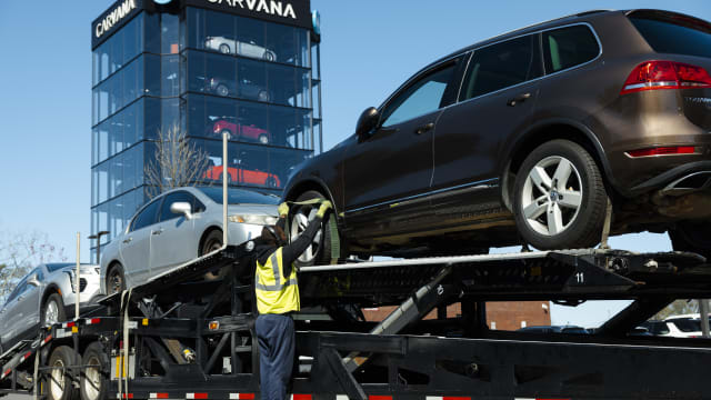 A worker loads vehicles onto a transporter at a Carvana vending machine location in Uniondale, New York, US, on Tuesday, April 16, 2024. Carvana Co. is scheduled to release earnings figures on May 1. Photographer: Angus Mordant/Bloomberg via Getty Images