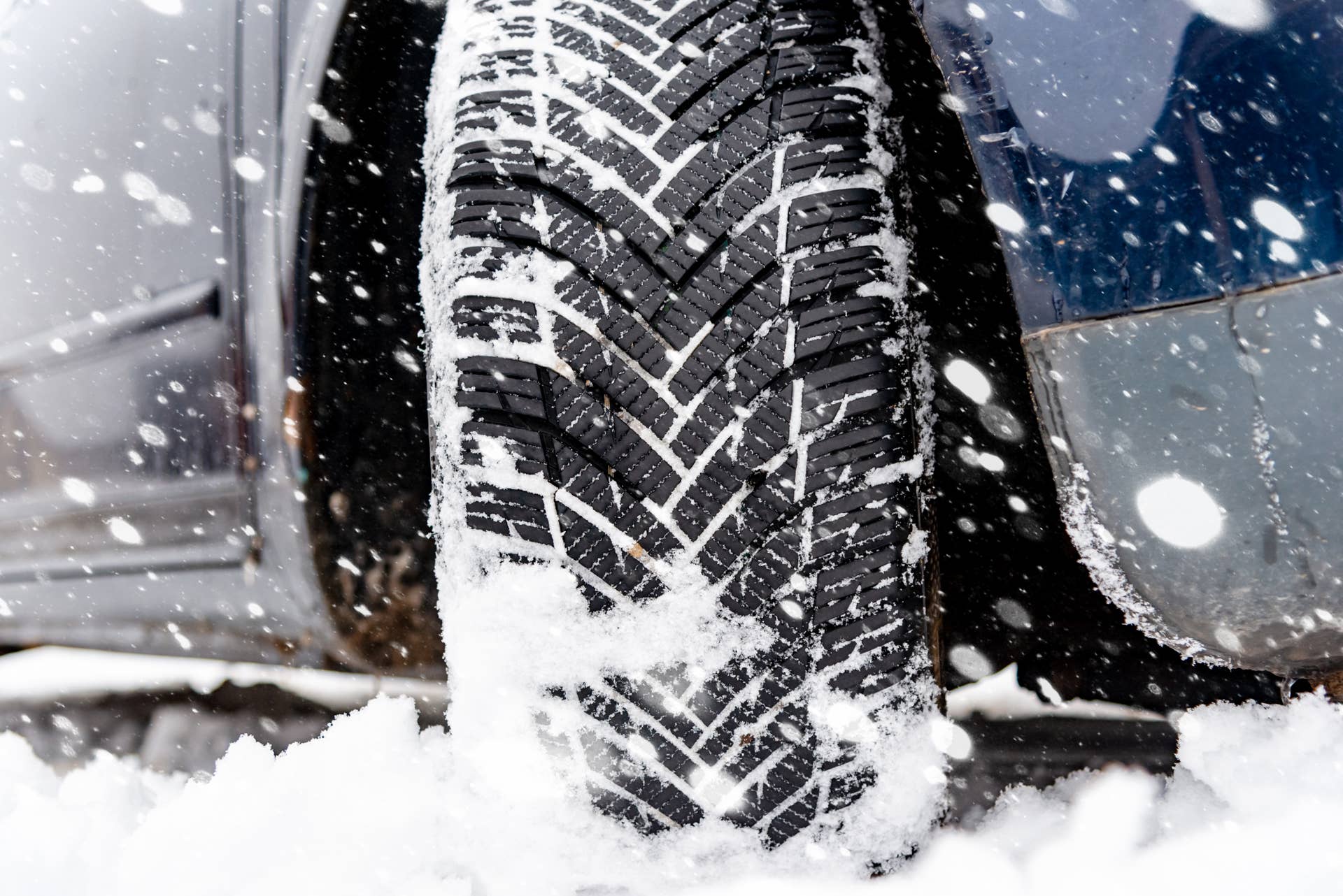 car-tires-on-winter-road-covered-with-snowvehicle-on-snowy-alleywinter-tiredetail-of-car-tires-in-winter-on-the-road-covered-with-snow.jpg