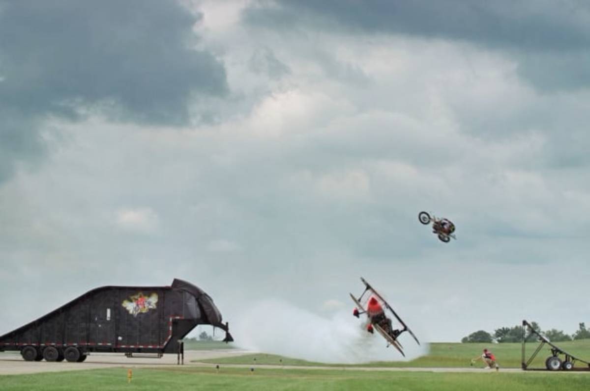 Watch this motocross rider jump a biplane at the 2014 Cameron Air Show
