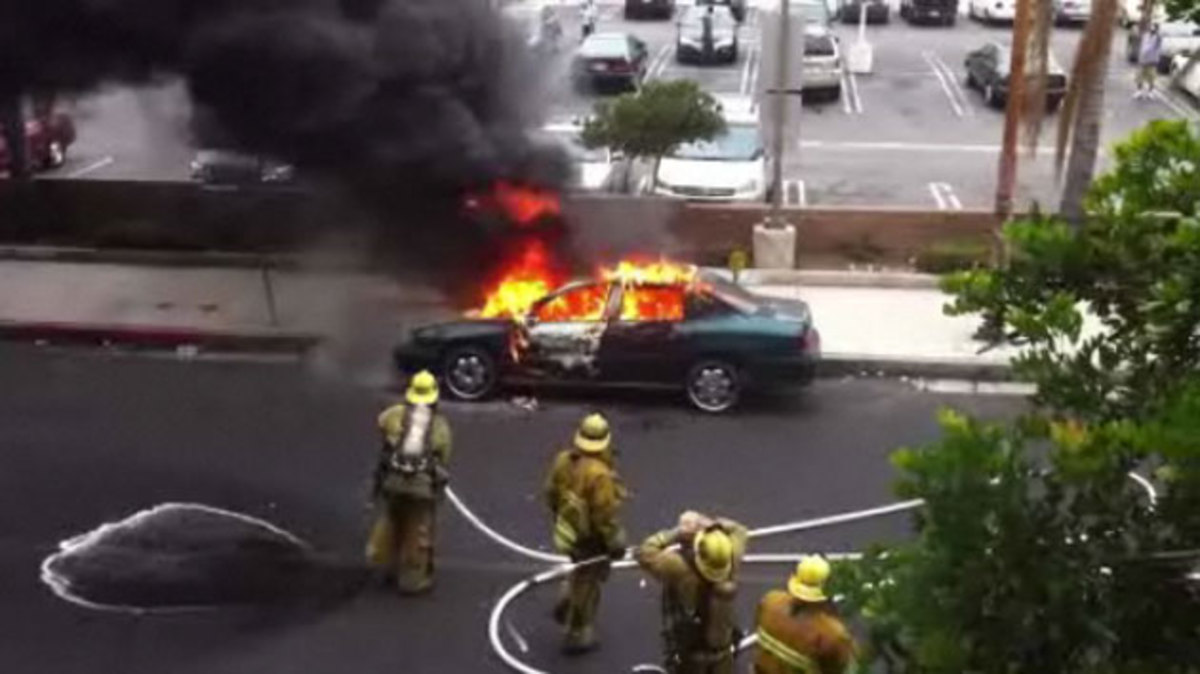 Boss firefighter keeps spraying after burning car blows up in his 