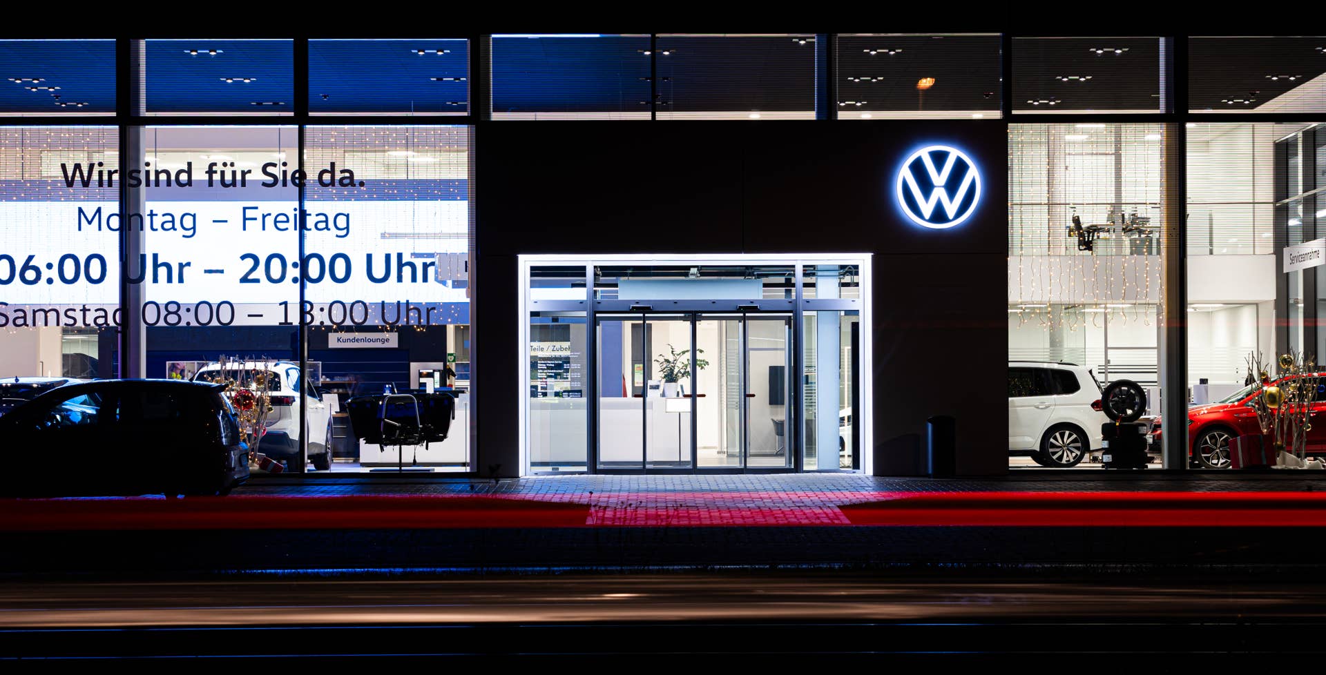 Vehicles drive past a Volkswagen dealership in Lower Saxony, Hanover.