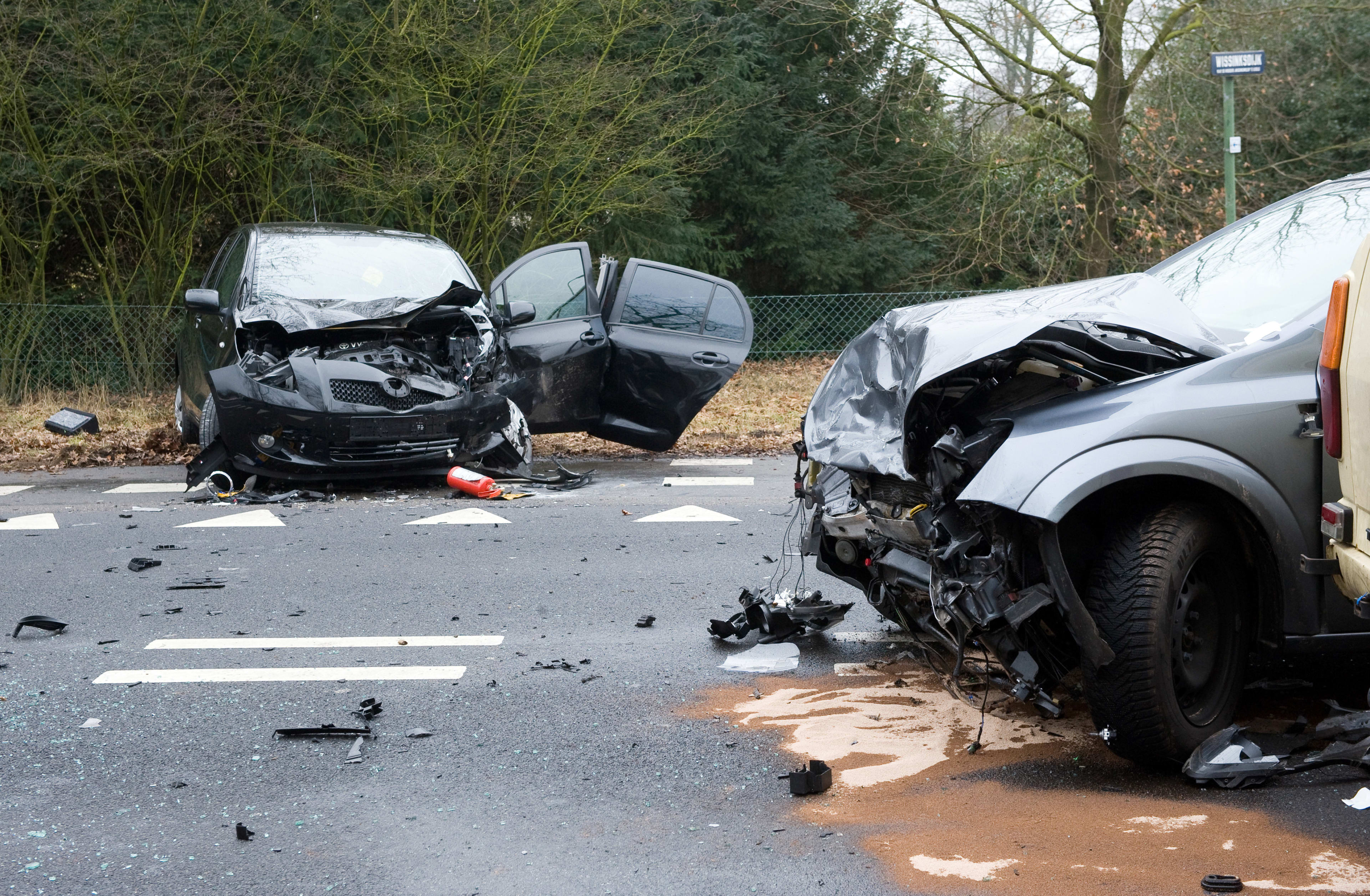 Two cars who crashed into another car on a interstate road