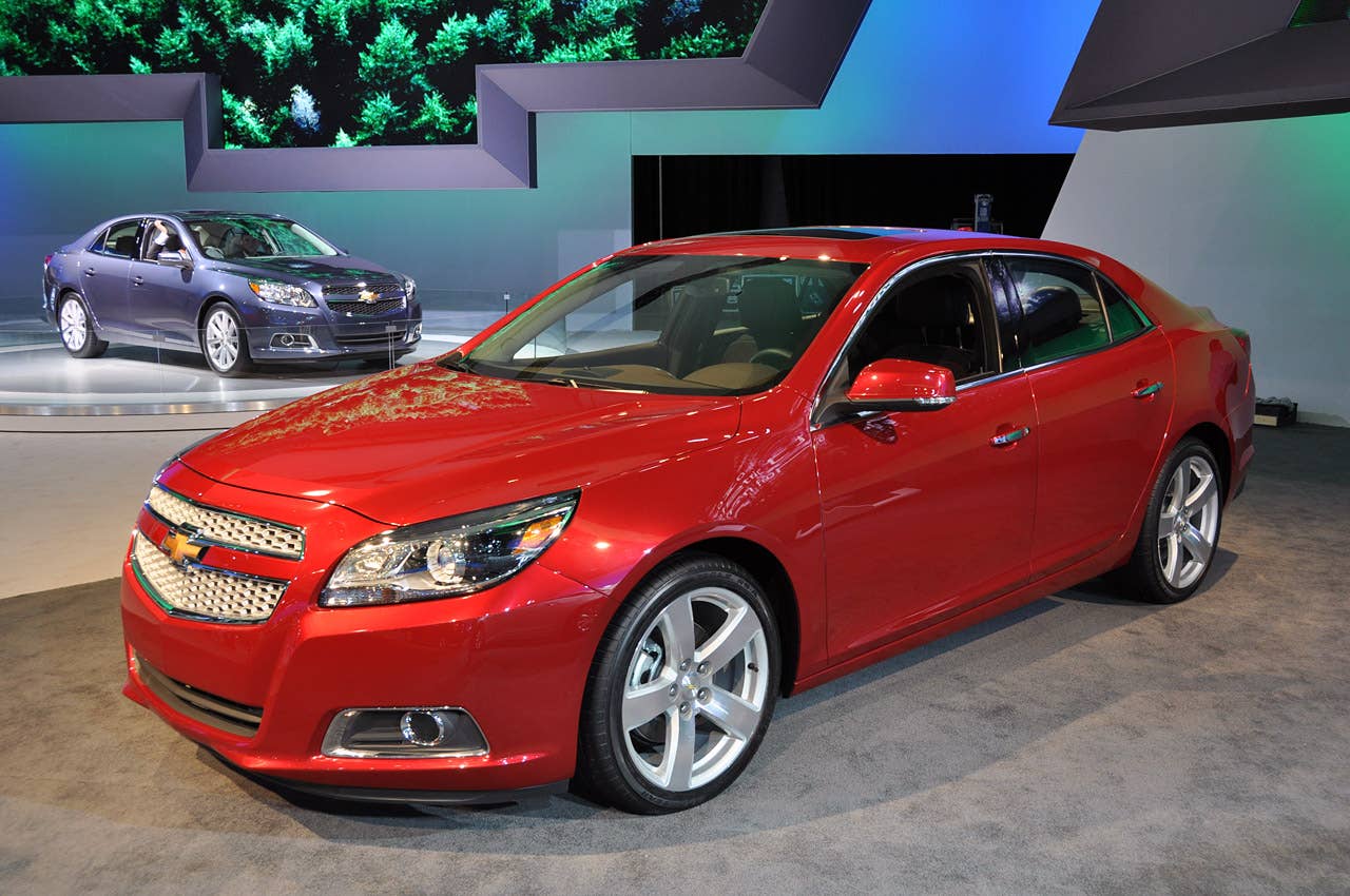Red Chevy Malibu sedan on stage