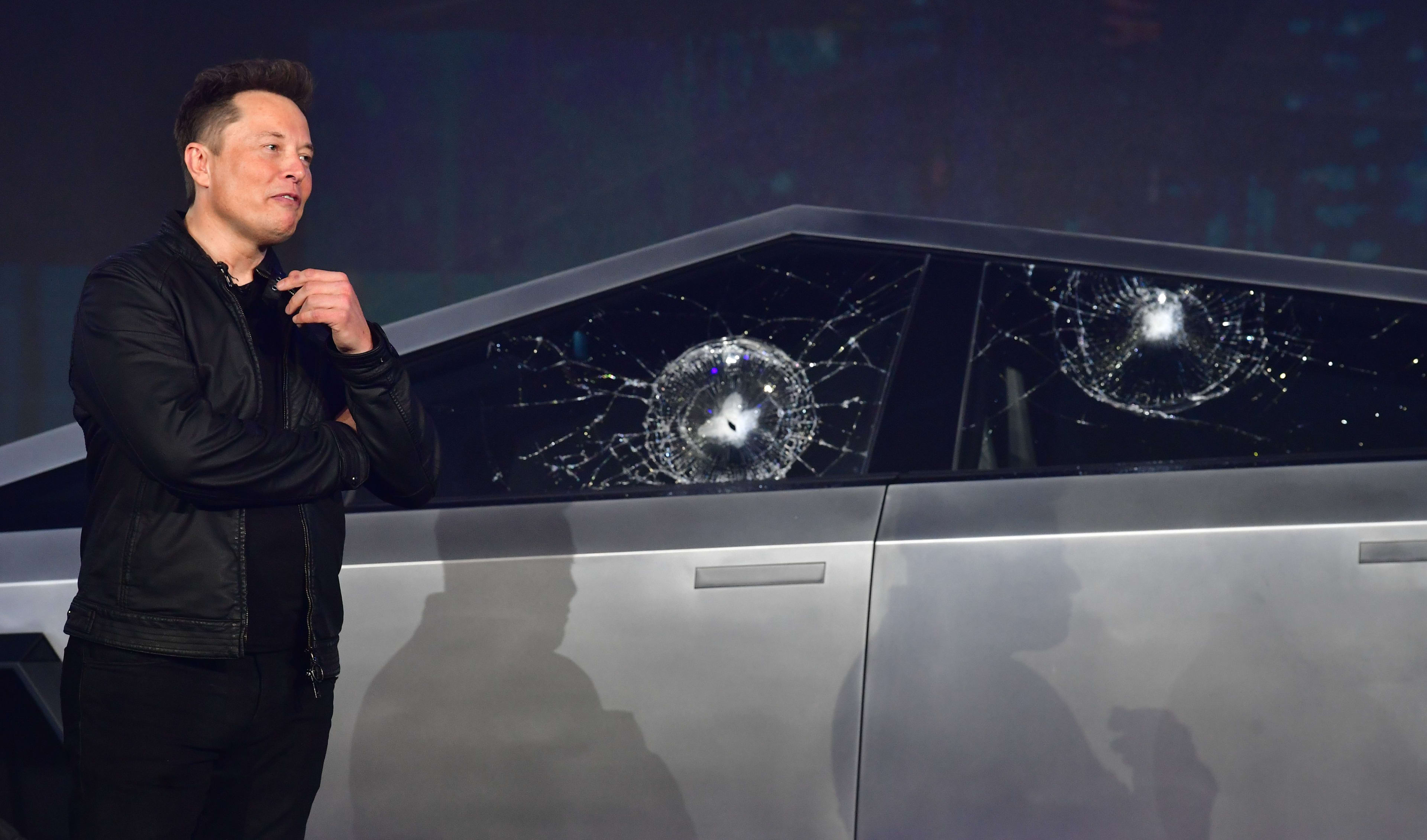 Tesla co-founder and CEO Elon Musk verbally reacts in front of the Tesla Cybertruck with broken windows following a demonstration that did not go as planned on November 21, 2019, at Tesla Design Center in Hawthorne, California.
