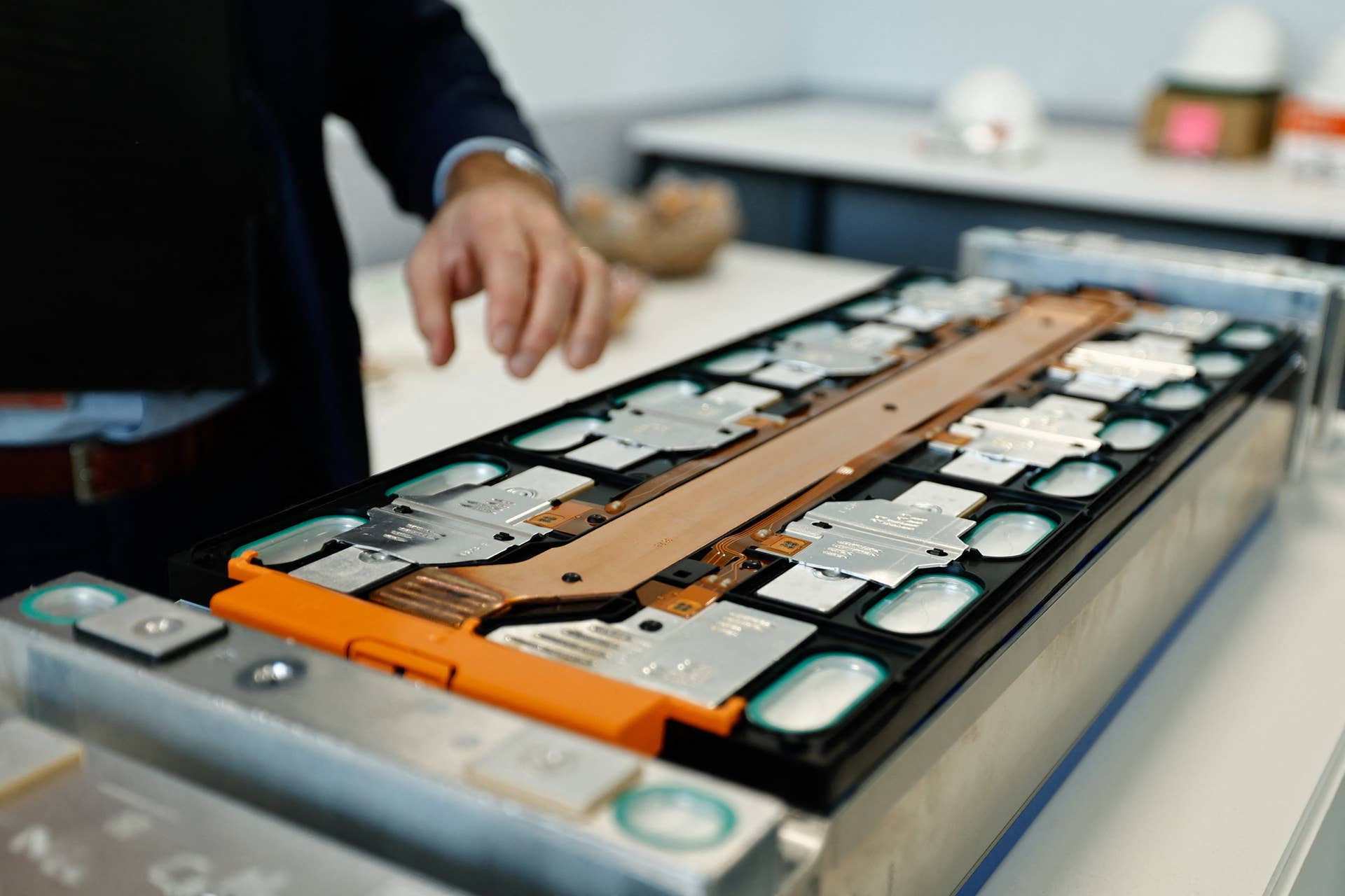 An employee shows a battery at the Automotive Cells Company (ACC) Gigafactory, which produces lithium-ion batteries for electric vehicles (EVs), in Douvrin, northern France.