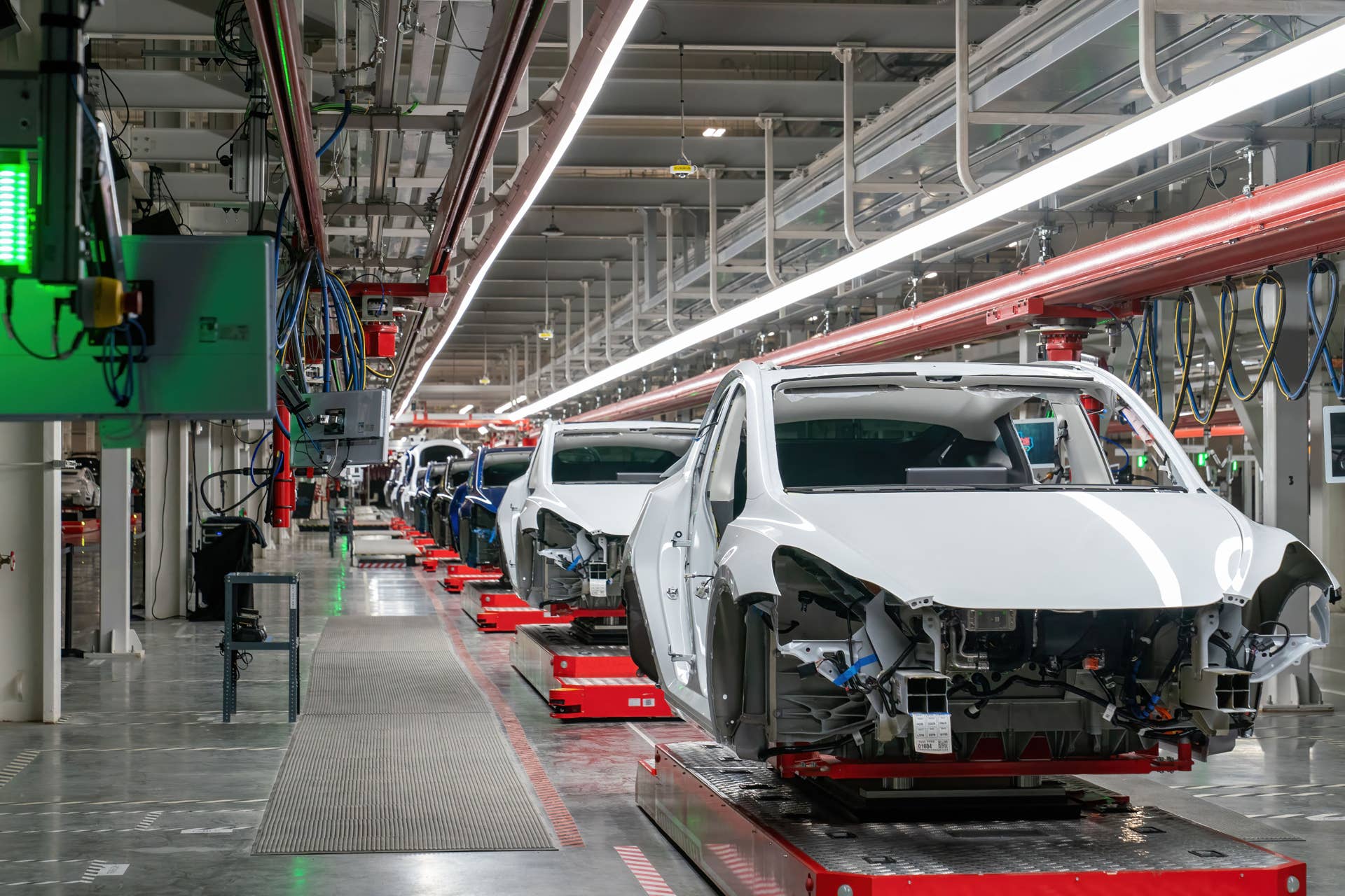 Cars are seen on the assembly line during a tour of the Tesla Giga Texas manufacturing facility ahead of the "Cyber Rodeo" grand opening party on April 7, 2022 in Austin, Texas. - Tesla welcomed throngs of  electric car lovers to Texas on April 7 for a huge party inaugurating a "gigafactory" the size of 100 profesional soccer fields. (Photo by SUZANNE CORDEIRO / AFP) (Photo by SUZANNE CORDEIRO/AFP via Getty Images)