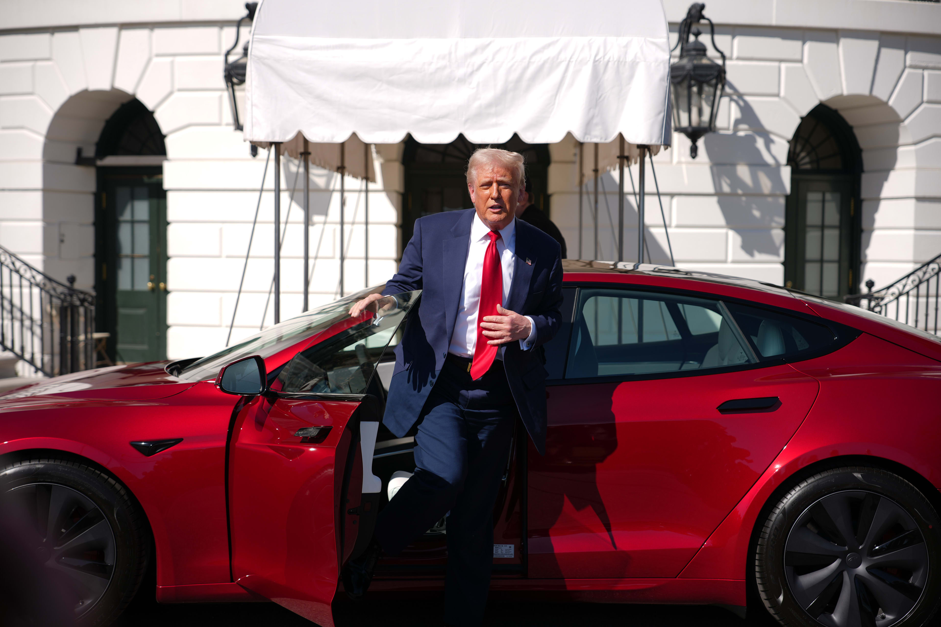 Donald Trump exiting a Tesla Model S
