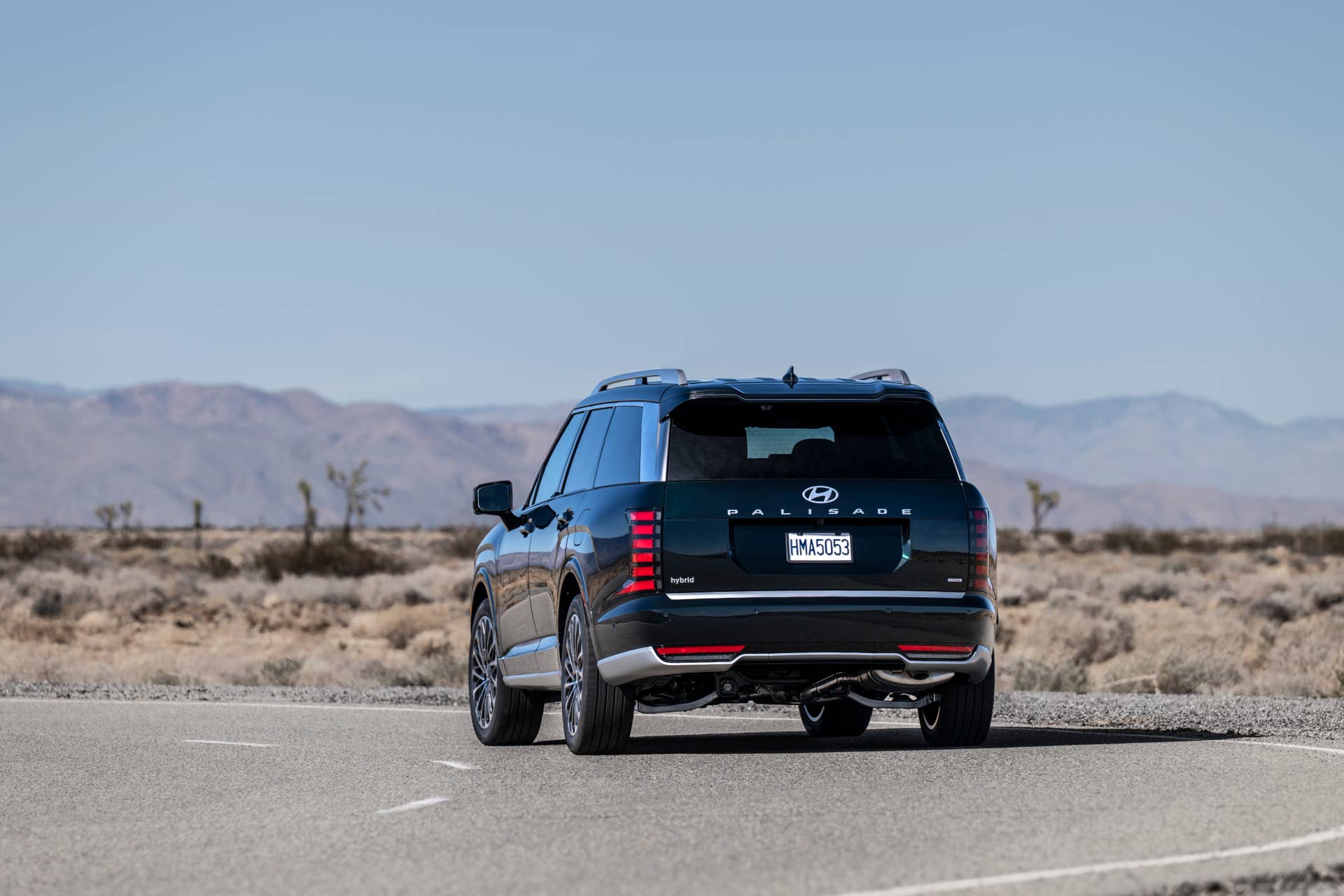 2026 Hyundai Palisade towing a large camper through a forest