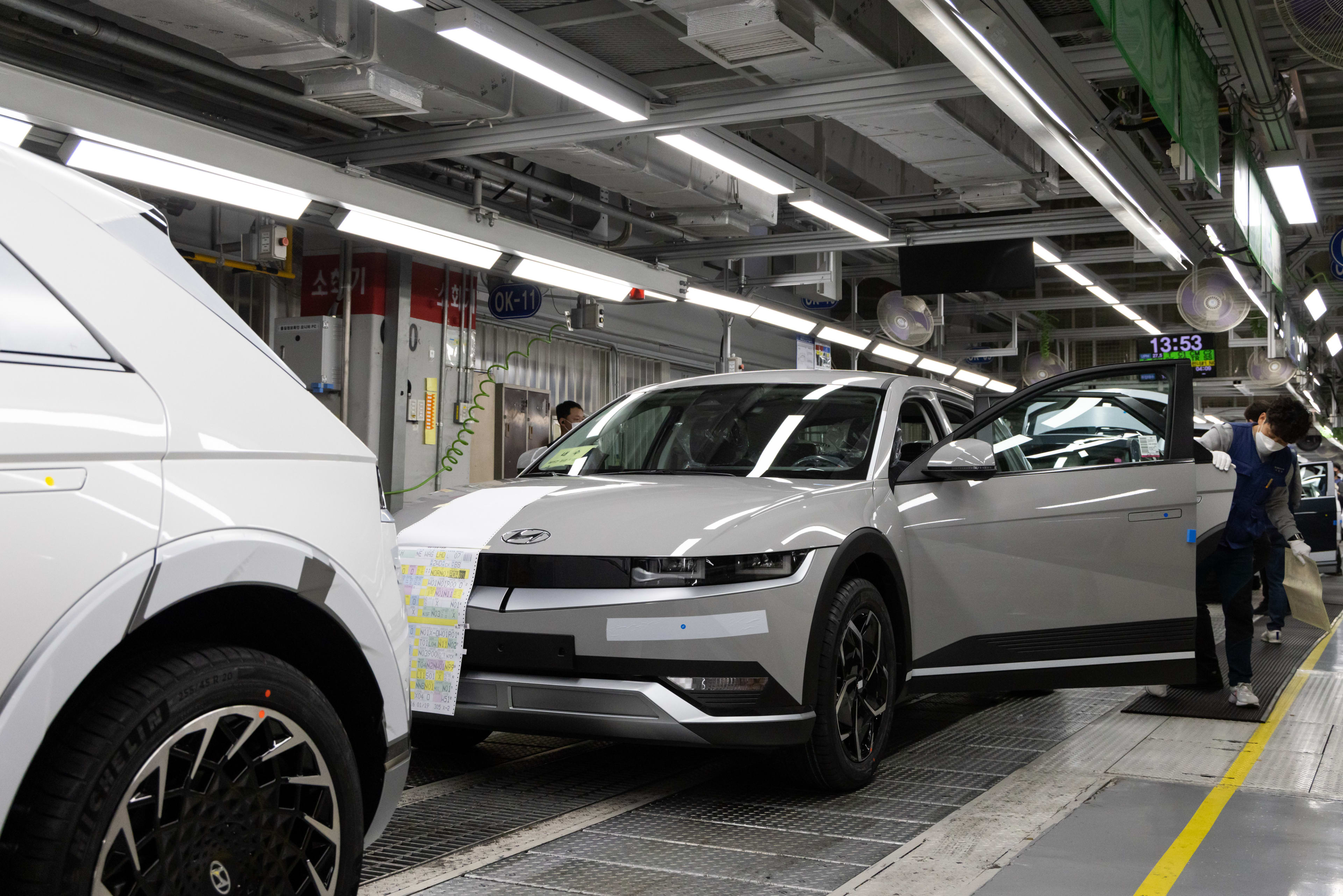 Employees inspect Hyundai Motor Co. Ioniq 5 electric vehicles (EV) on the final inspection line at the company’s Ulsan plant in Ulsan, South Korea, on Thursday, Jan. 20, 2022. <br />