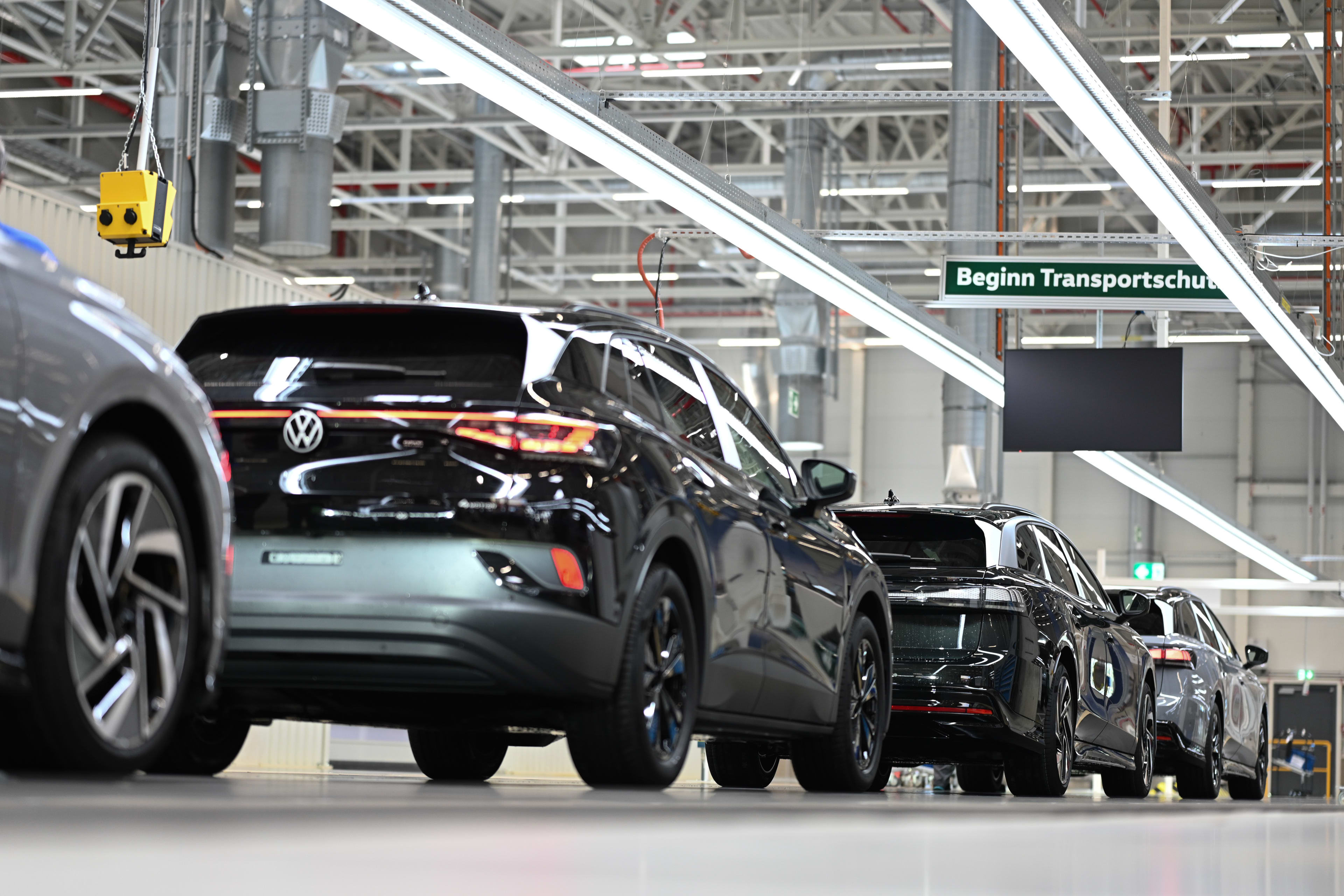 Electric cars roll through the final assembly line at the VW plant in Emden, Germany