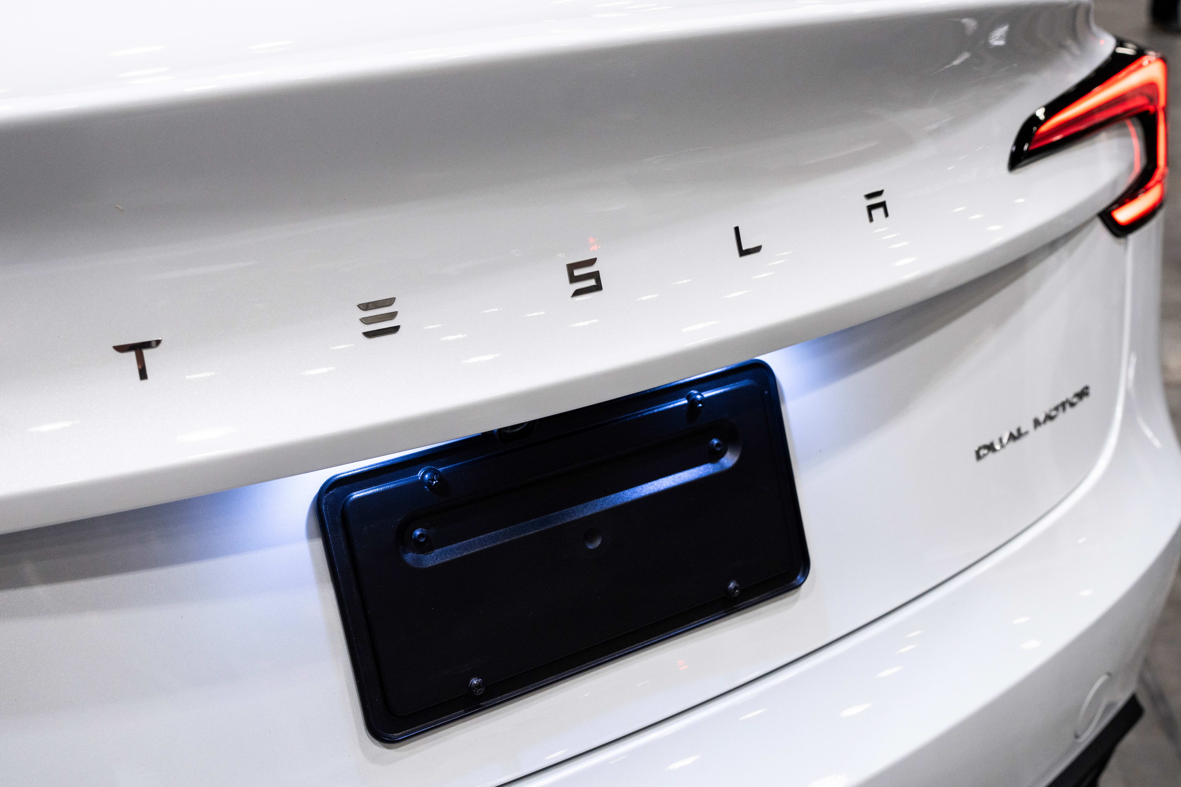 A Tesla Model 3 electric vehicle at the Everything Electric show in Vancouver, British Columbia, Canada, on Friday, Sept. 5, 2025. Canada announced that it would scrap the 2026 EV sales mandate and launch a regulatory review. Photographer: Paige Taylor White/Bloomberg via Getty Images