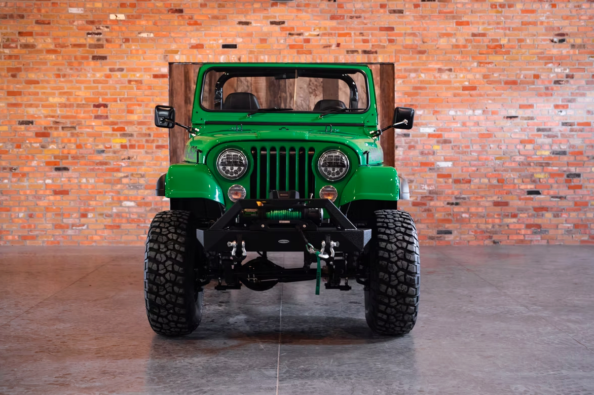 Jeep CJ-8 Scrambler Restomod by Blacksmith Garage: Python Green, Full Leather, Auction Oct 25 5 Jeep CJ-8 Scrambler ANV-JS2 Blacksmith Garage front
