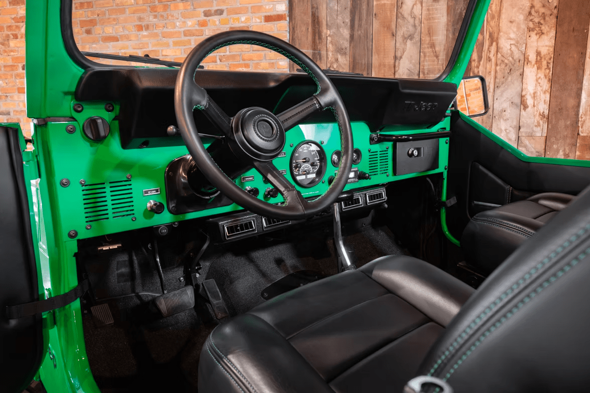 Jeep CJ-8 Scrambler Restomod by Blacksmith Garage: Python Green, Full Leather, Auction Oct 25 11 Jeep CJ-8 Scrambler ANV-JS2 Blacksmith Garage front interior dashboard