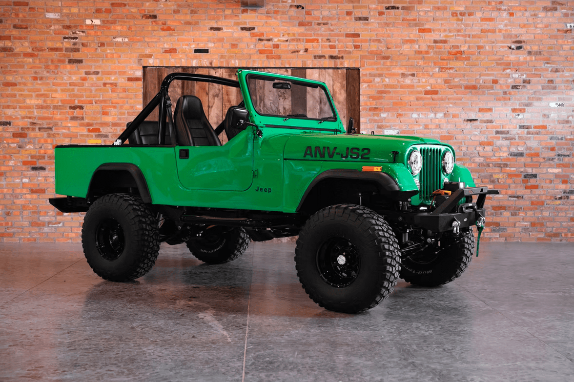 Jeep CJ-8 Scrambler Restomod by Blacksmith Garage: Python Green, Full Leather, Auction Oct 25 2 Jeep CJ-8 Scrambler ANV-JS2 Blacksmith Garage front quarter roof off
