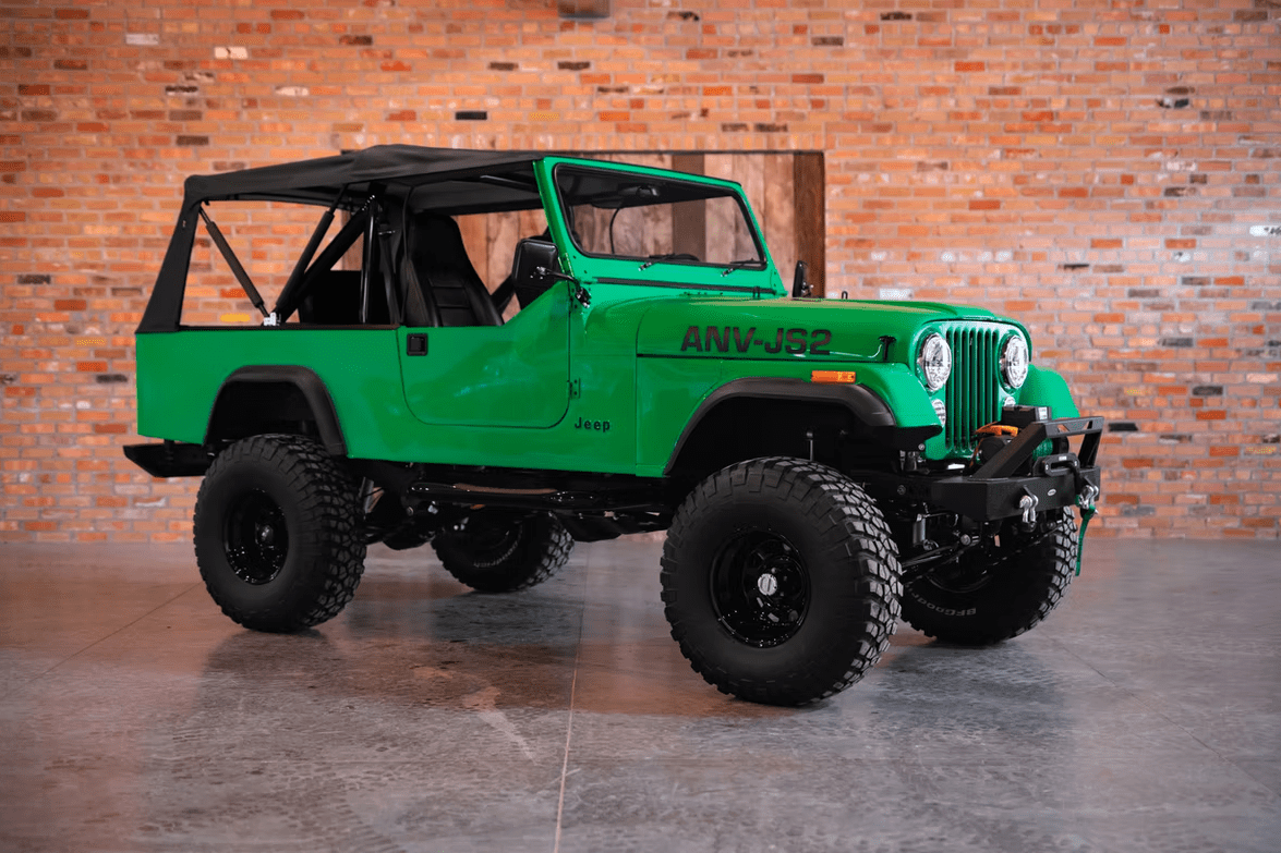 Jeep CJ-8 Scrambler Restomod by Blacksmith Garage: Python Green, Full Leather, Auction Oct 25 6 Jeep CJ-8 Scrambler ANV-JS2 Blacksmith Garage front quarter roof on