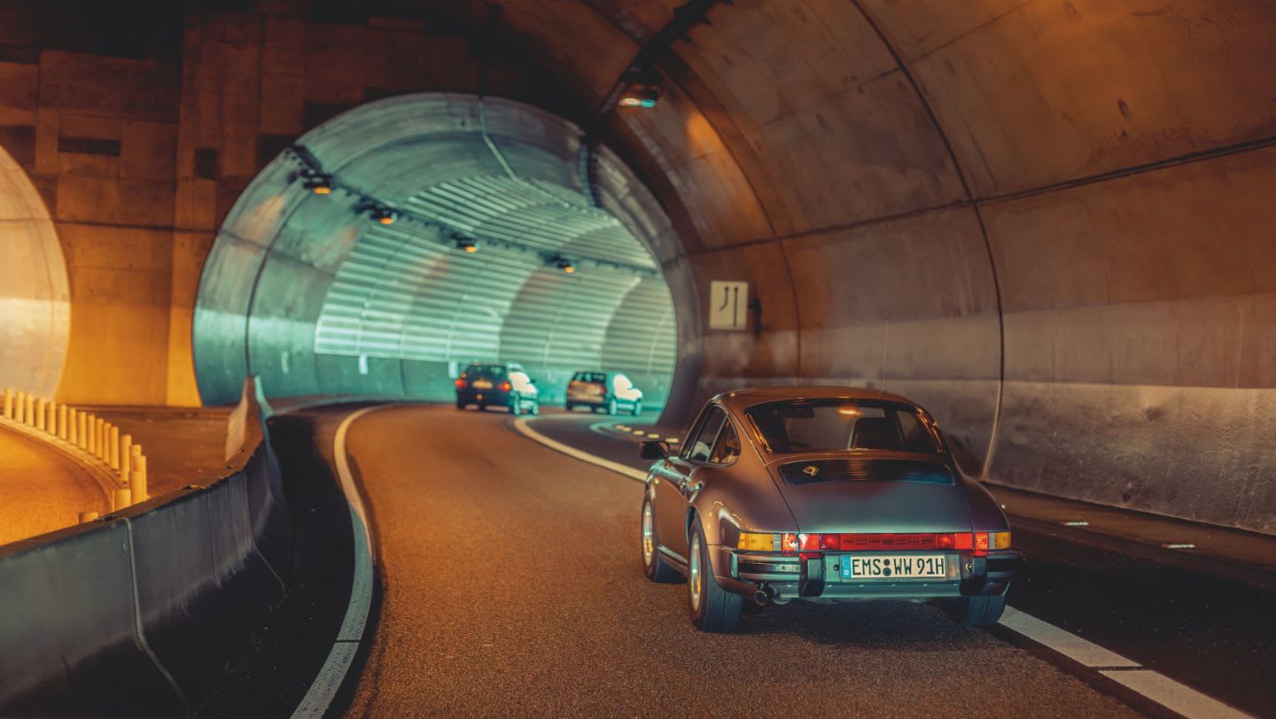 Porsche 911 approaching a tunnel