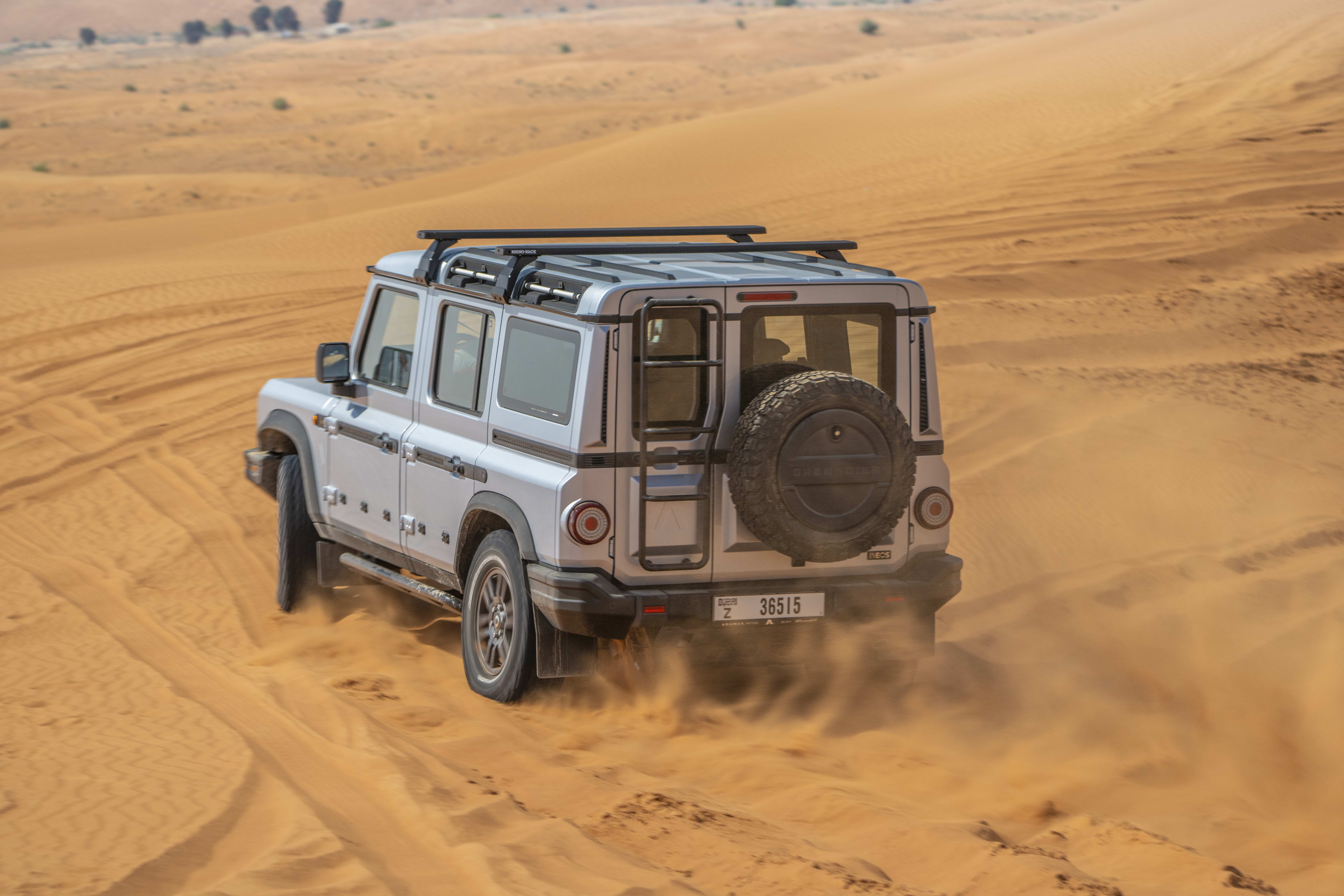 Despite Sales Growth, Ineos Automotive financial struggles Lead to Layoffs 5 Ineos Grenadier in the sand, rear three-quarters.