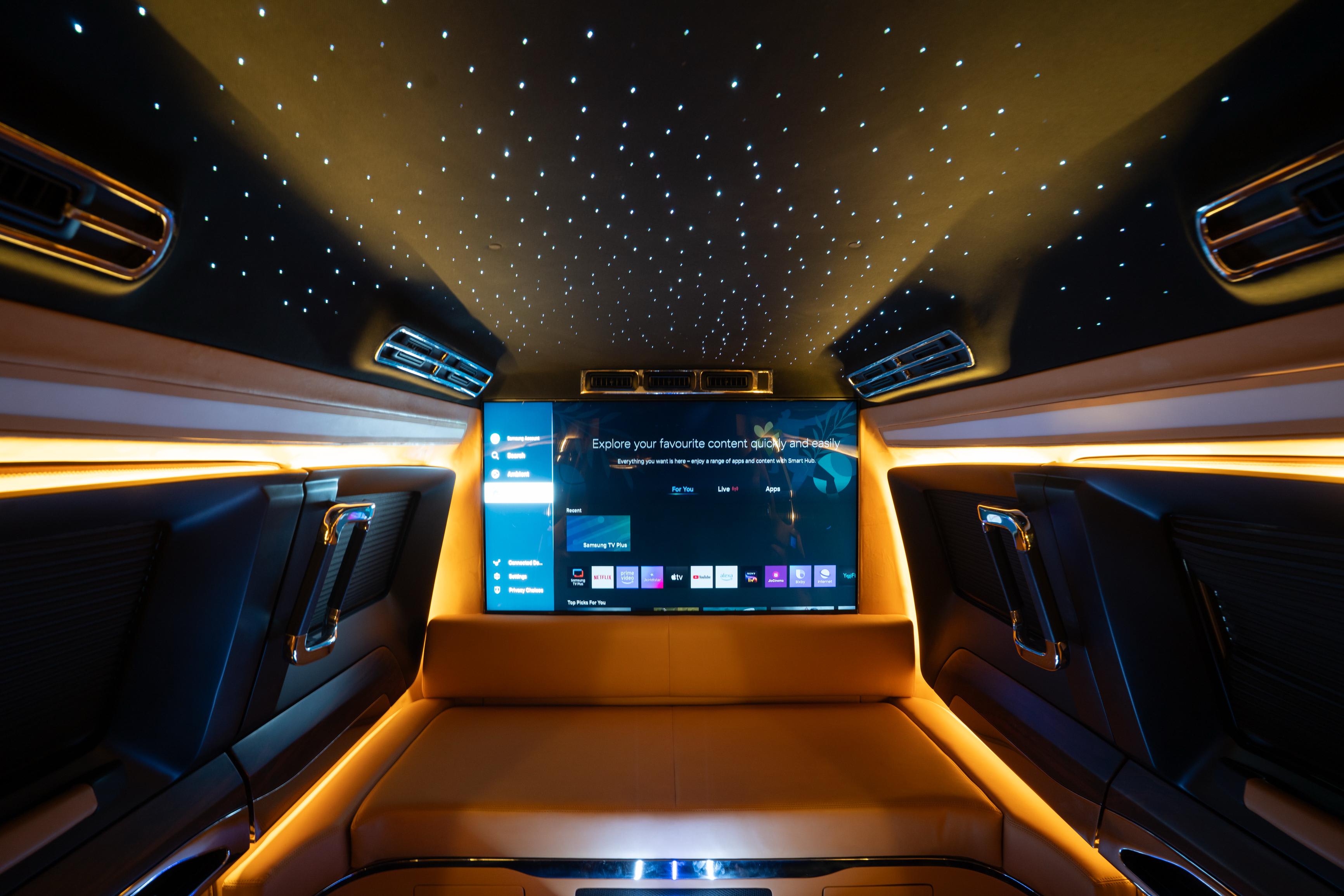 Toyota Land Cruiser 300 limo Specs: Starlight Headliner and Twin-Turbo V6 7 Interior of the custom Toyota Land Cruiser 300 Limousine with wide sofa, television screen and starlight headliner